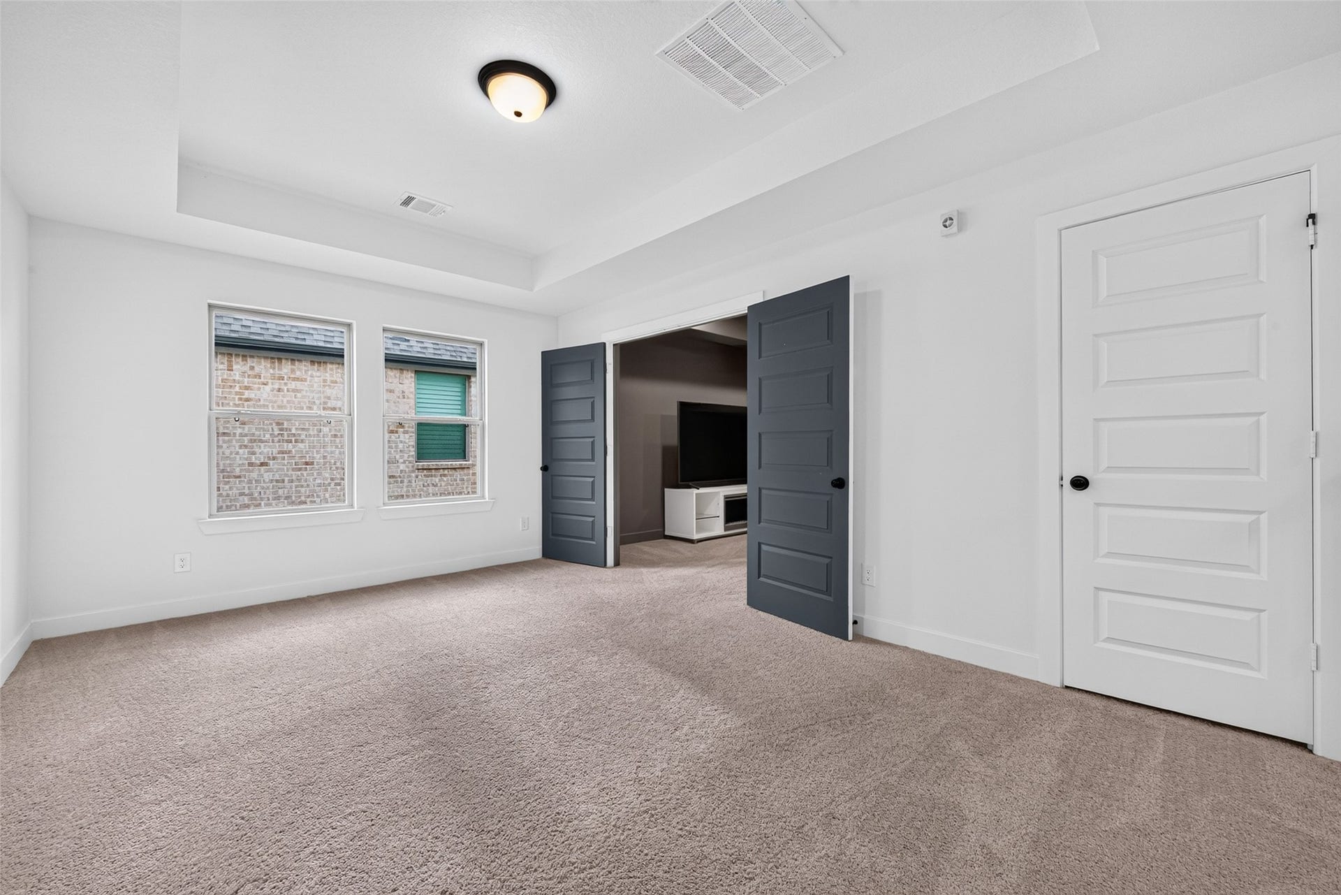 2511 Falling Fig Lane, Richmond, TX 77406 An expansive game room featuring elegant tray ceilings and direct access to the media room, creating an exceptional setting for entertainment, recreation, and memorable gatherings