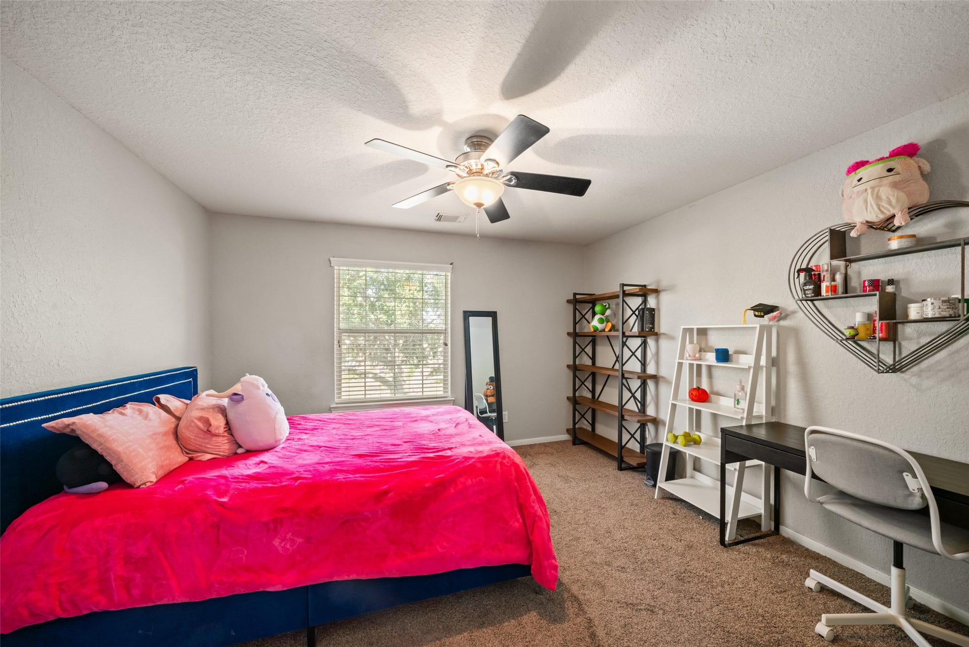 Another upstairs bedroom filled with natural light.