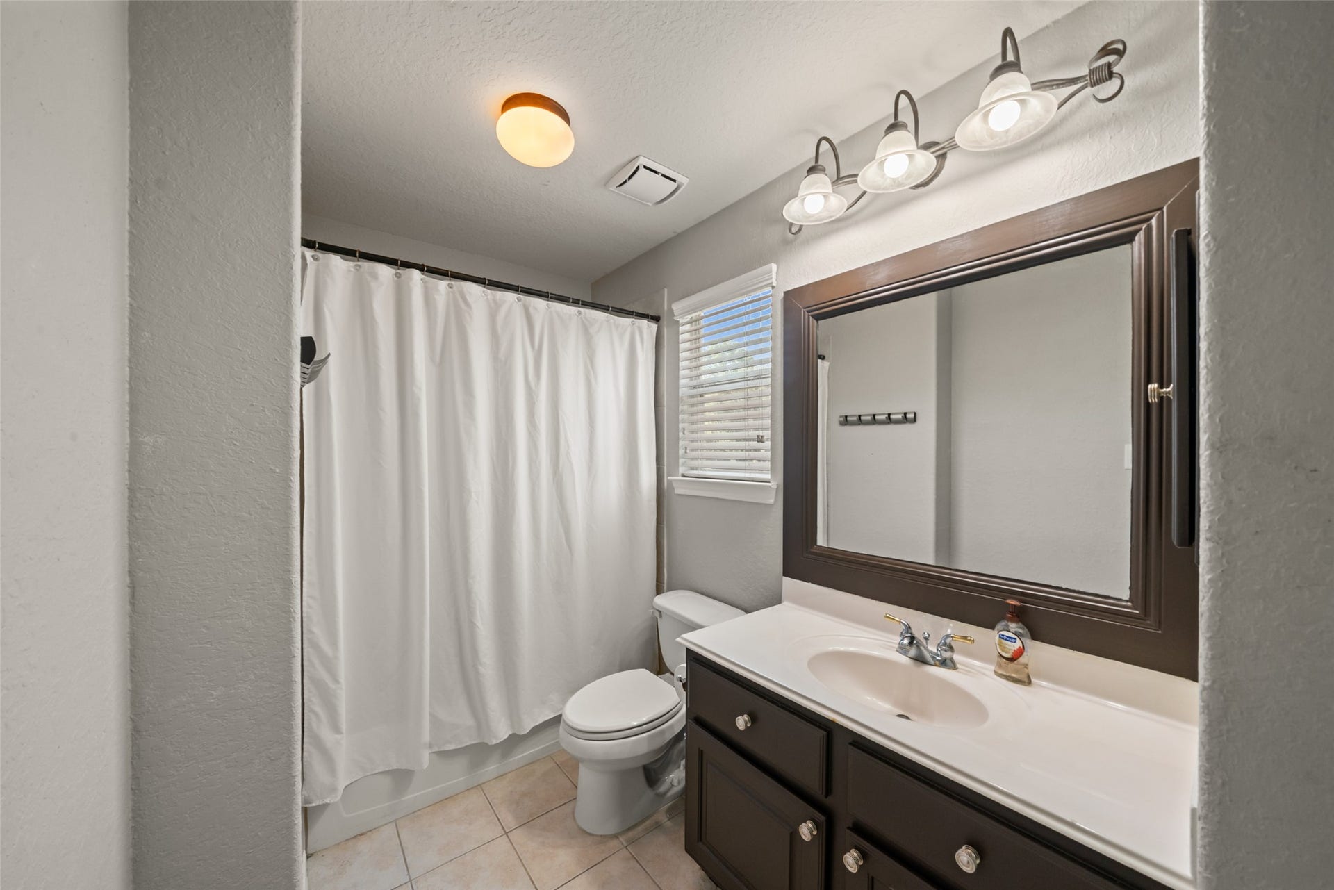 One of the two upstairs bathrooms with a full shower and tub combination.