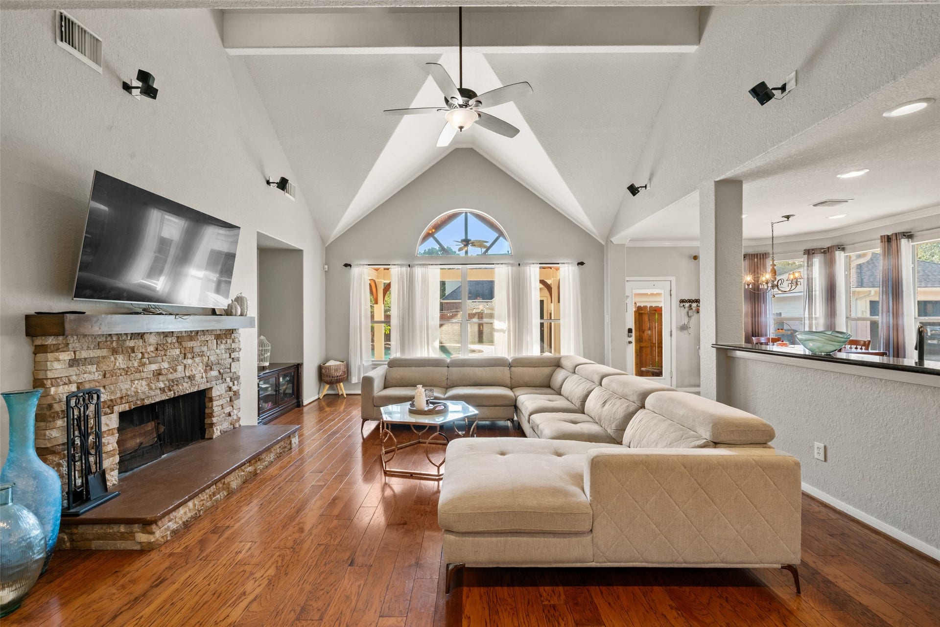 Inside, the soaring cathedral ceilings are flooded with natural light, creating an impressive living area.
