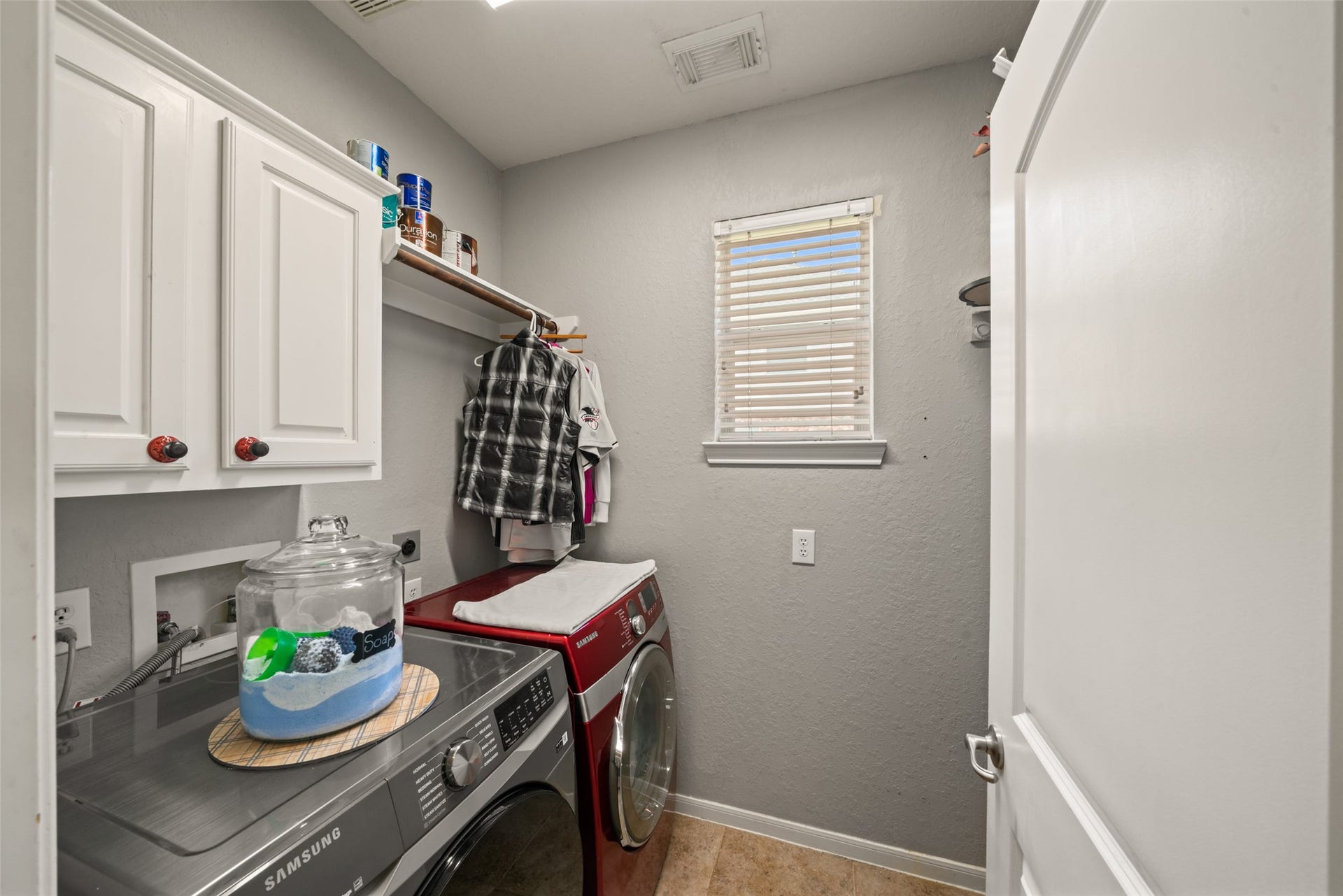 The dedicated laundry room has plenty of storage.