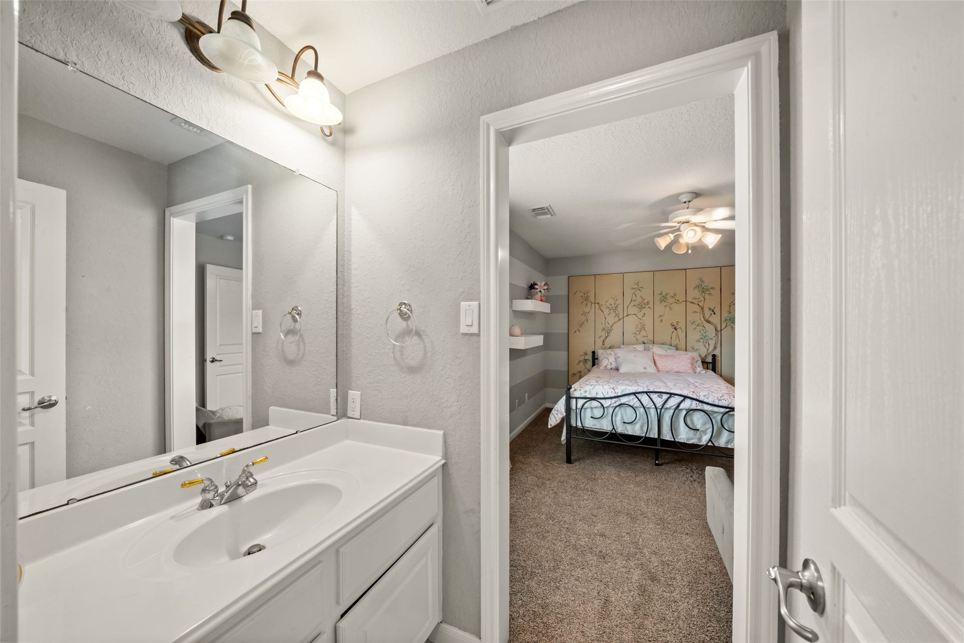 The vanity by the other bedroom of this shared bathroom offers everyday convenience!