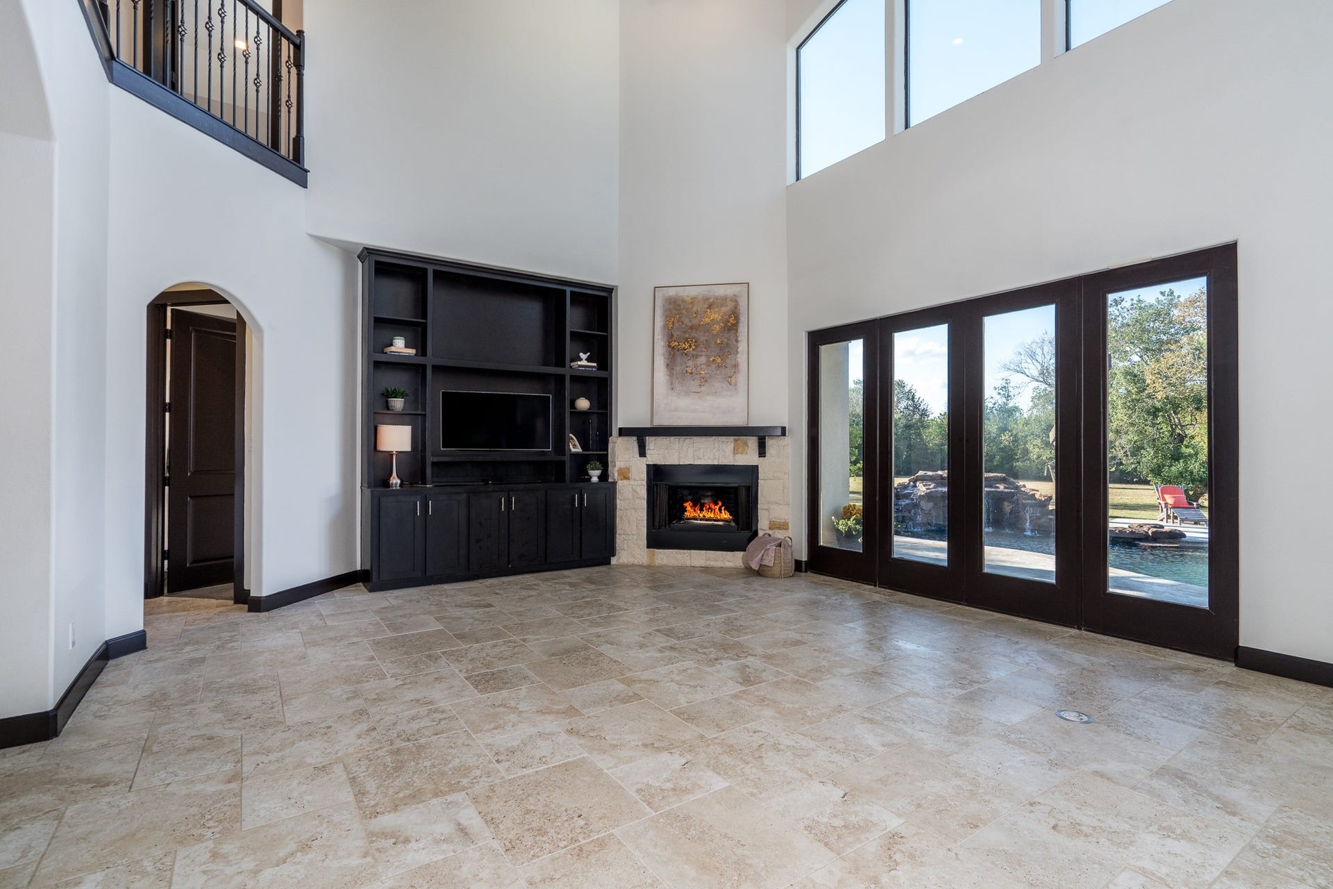 Enjoy pool views from your living space anchored by the stone /gas fireplace.