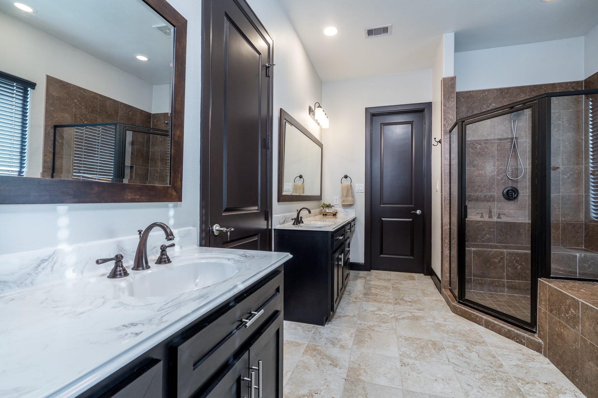En suite bath highlights include dual vanities (one with room for a makeup stool), walk-in shower with a seat and 2 large closets.