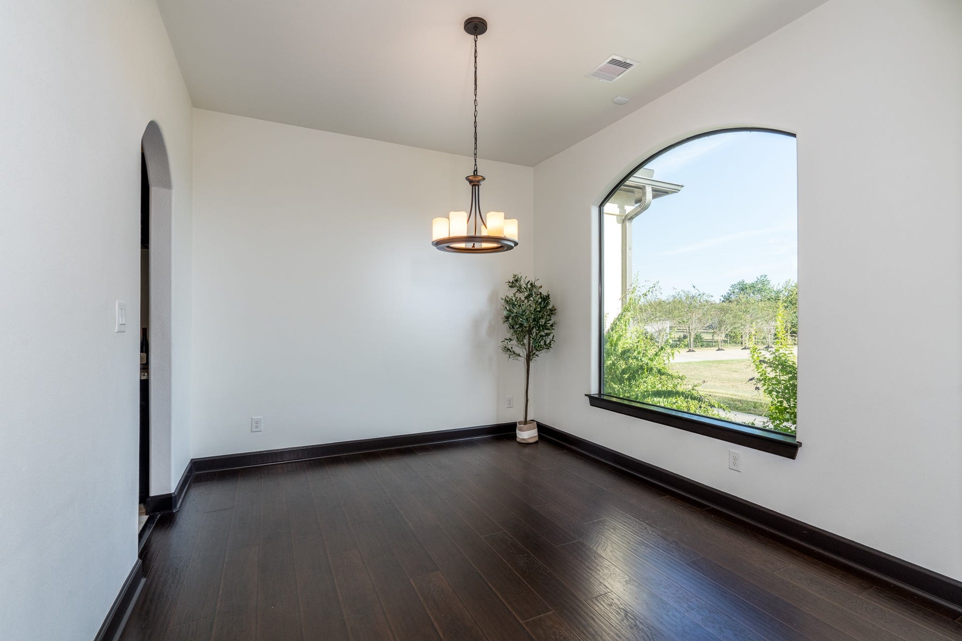 Formal dining off the entry has designer laminate wood flooring for durability and style.
