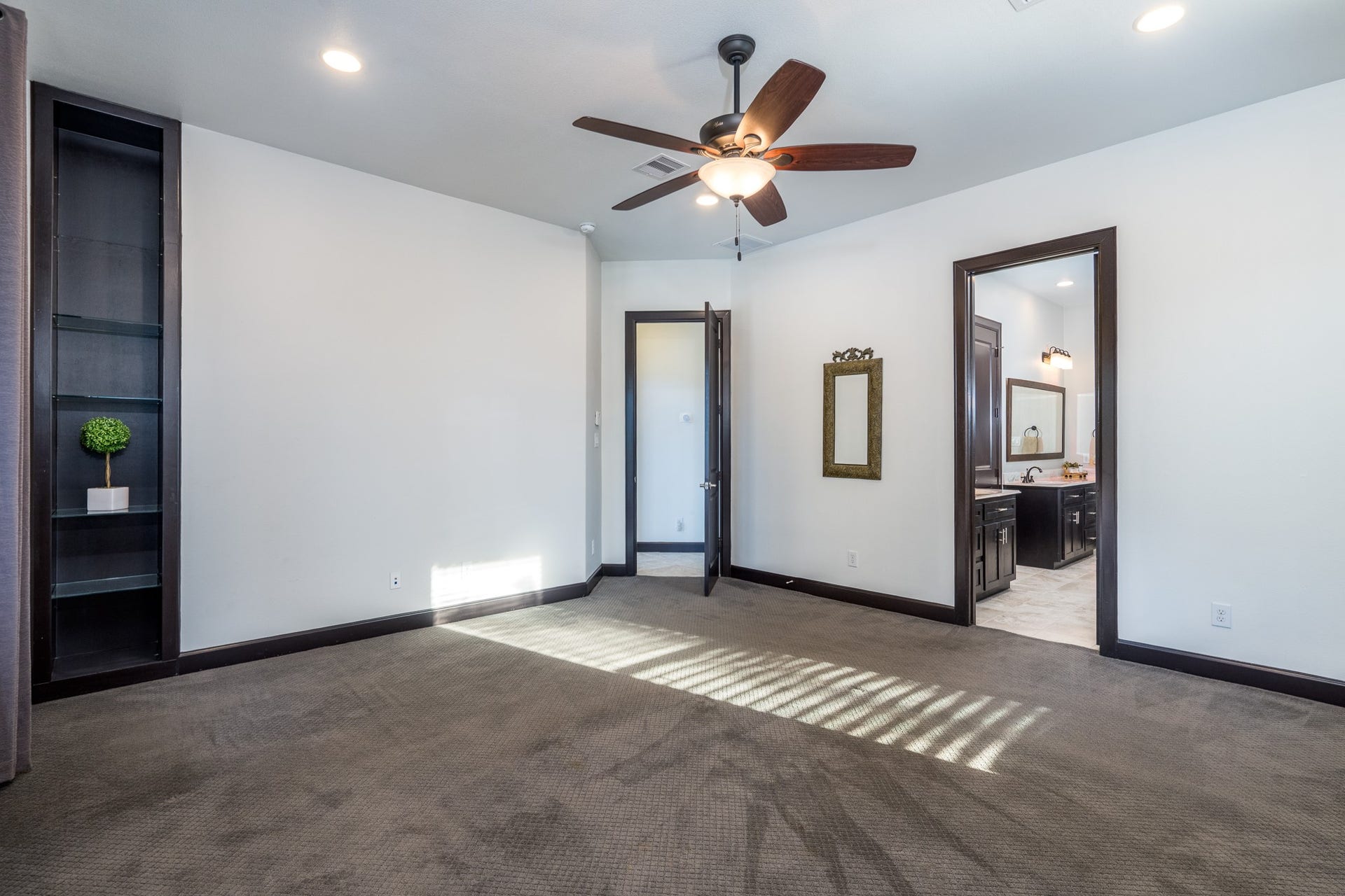 The serene space offers a custom built-in and plenty of room for a sitting area.