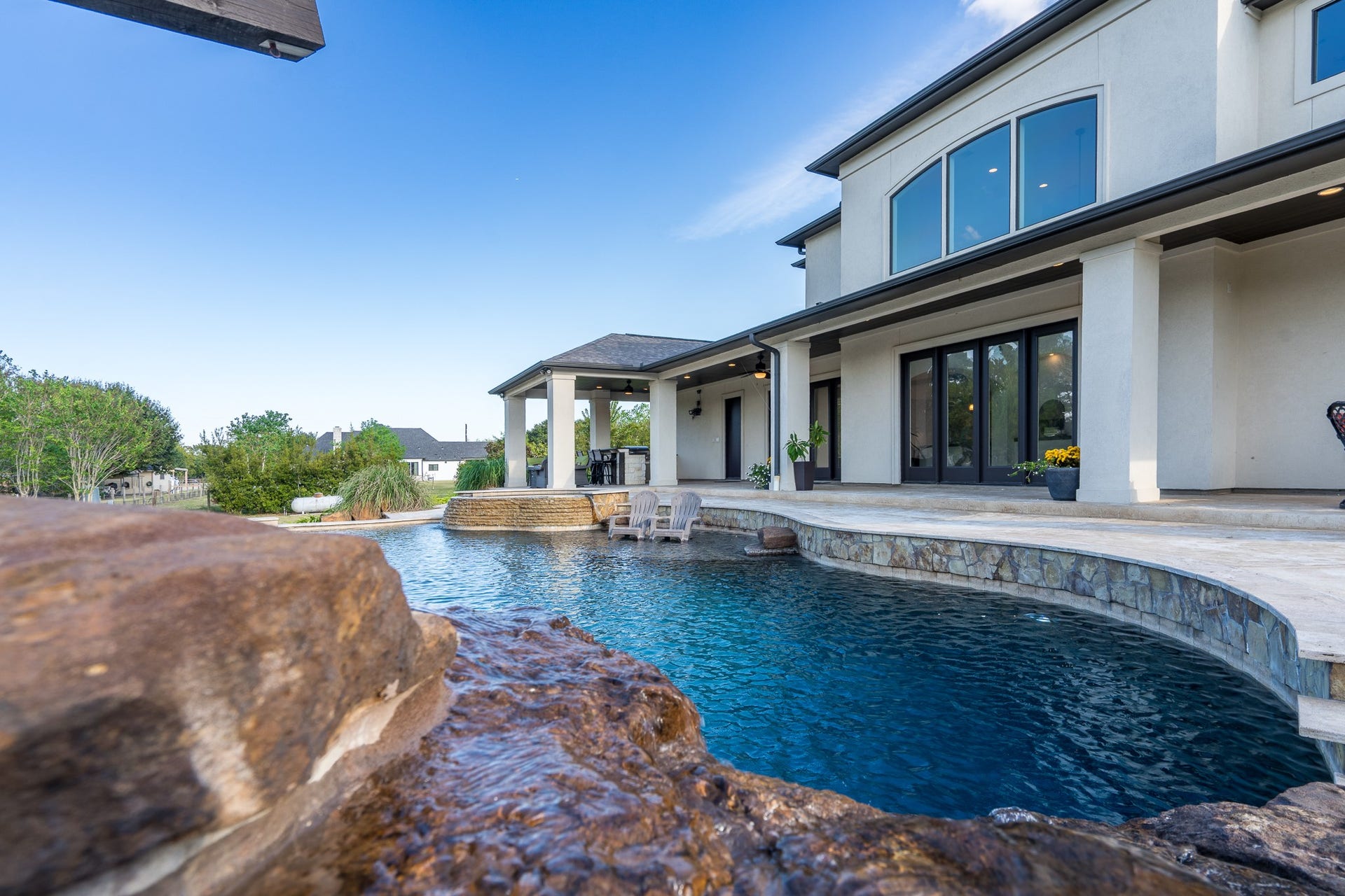 In addition to the rock waterfall / grotto, other water features include the spa's spillover.