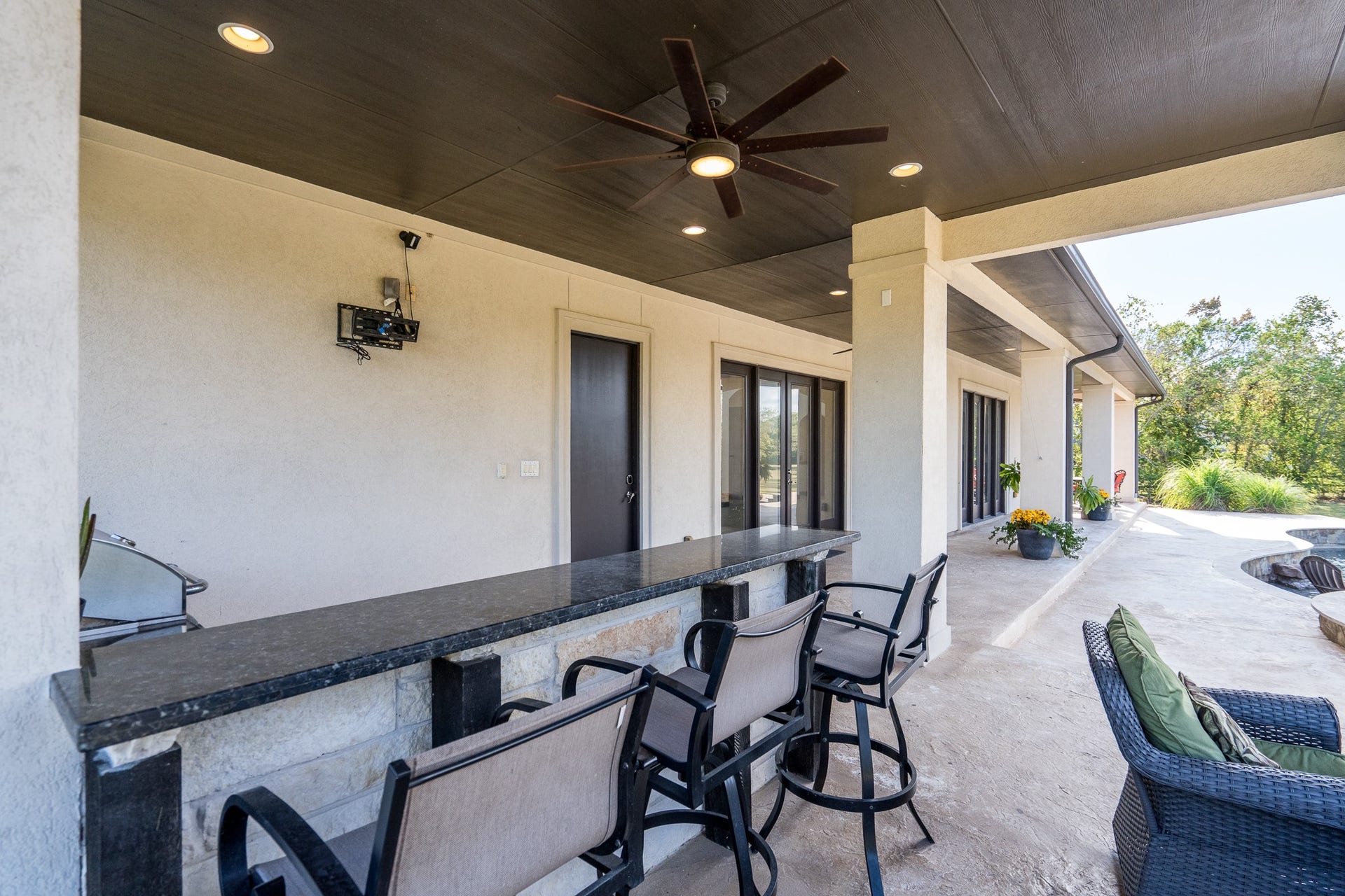 There are granite counters and a granite serving bar with views of where the TV can be mounted to watch fall ball.
