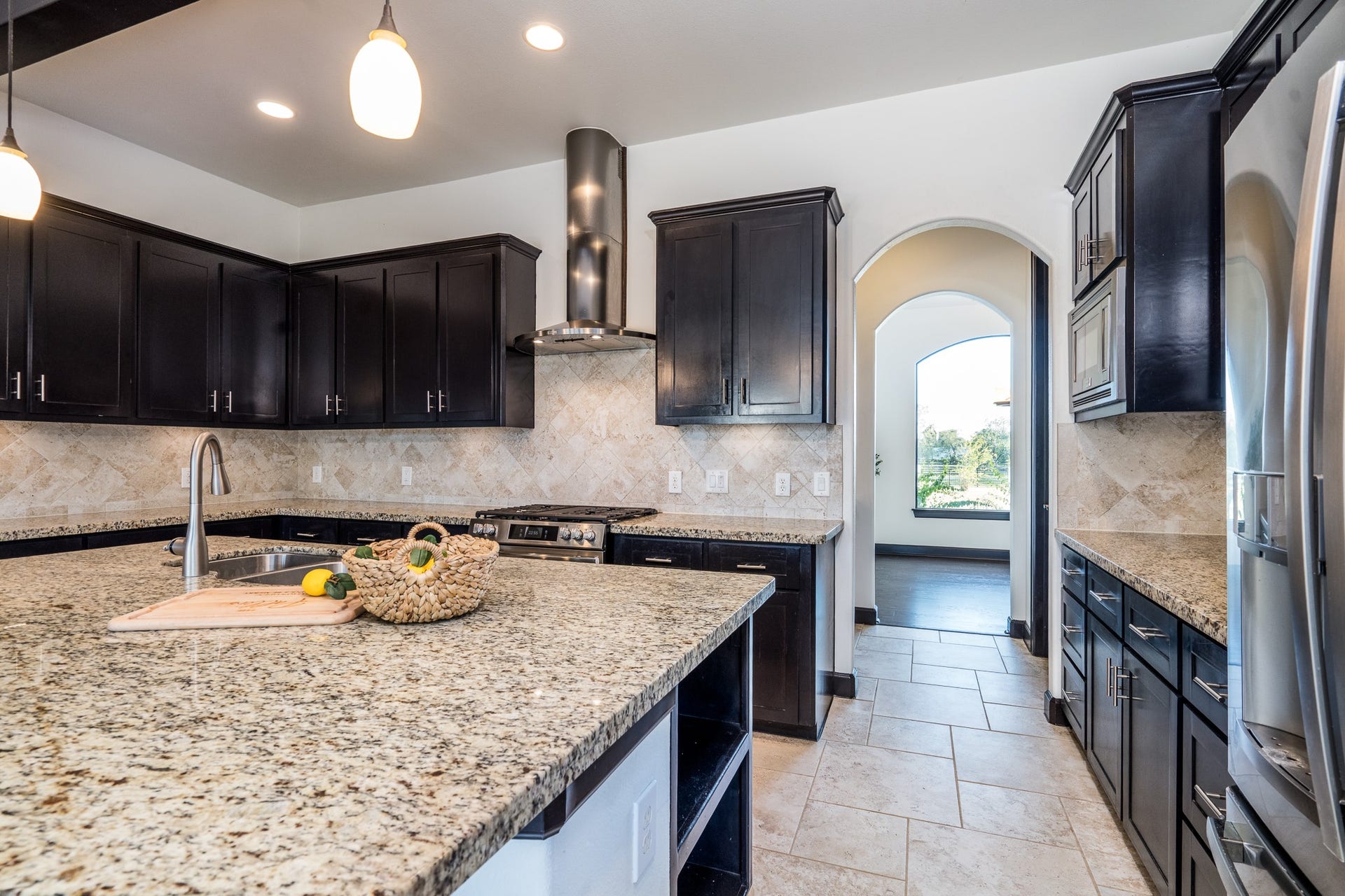Custom wood stain-grade cabinets in the kitchen which is connected to the dining by a butler's pantry.