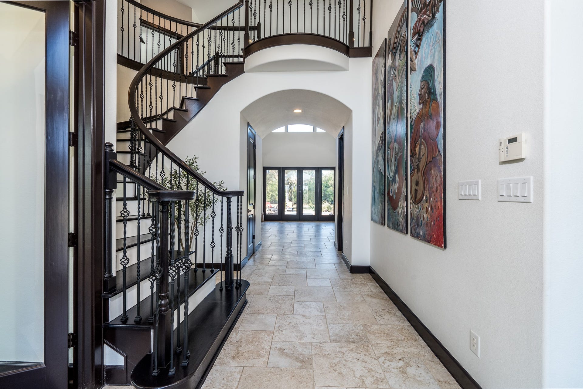 Gorgeous wrought iron baluster spiral staircase with wood stair treads and risers.