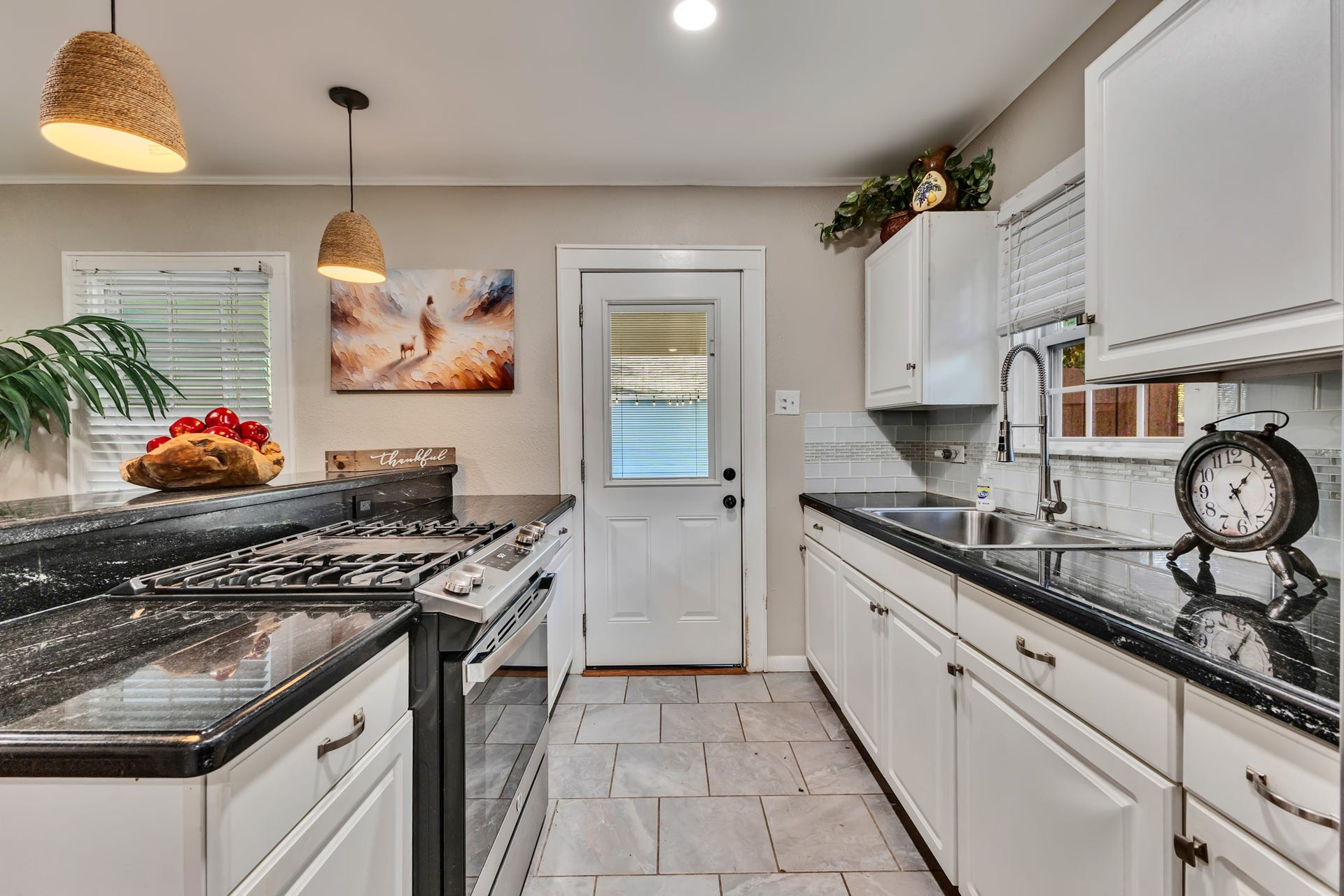 801 18th Avenue N, Texas City, TX 77590 A kitchen that combines style with everyday functionality! White cabinetry, dark countertops, stainless steel appliances, and ample preparation space make cooking and entertaining convenient without sacrificing visual appeal.