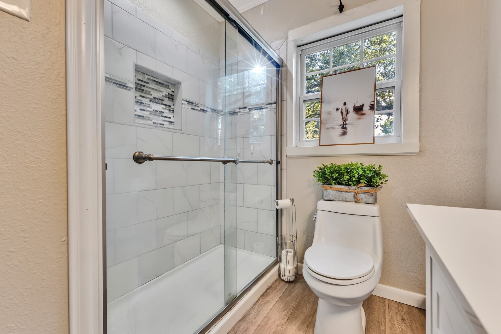 801 18th Avenue N, Texas City, TX 77590 A glass-enclosed shower adds a clean, modern touch to this charming home. The tiled surround and natural light create an appealing space that balances style and everyday convenience.