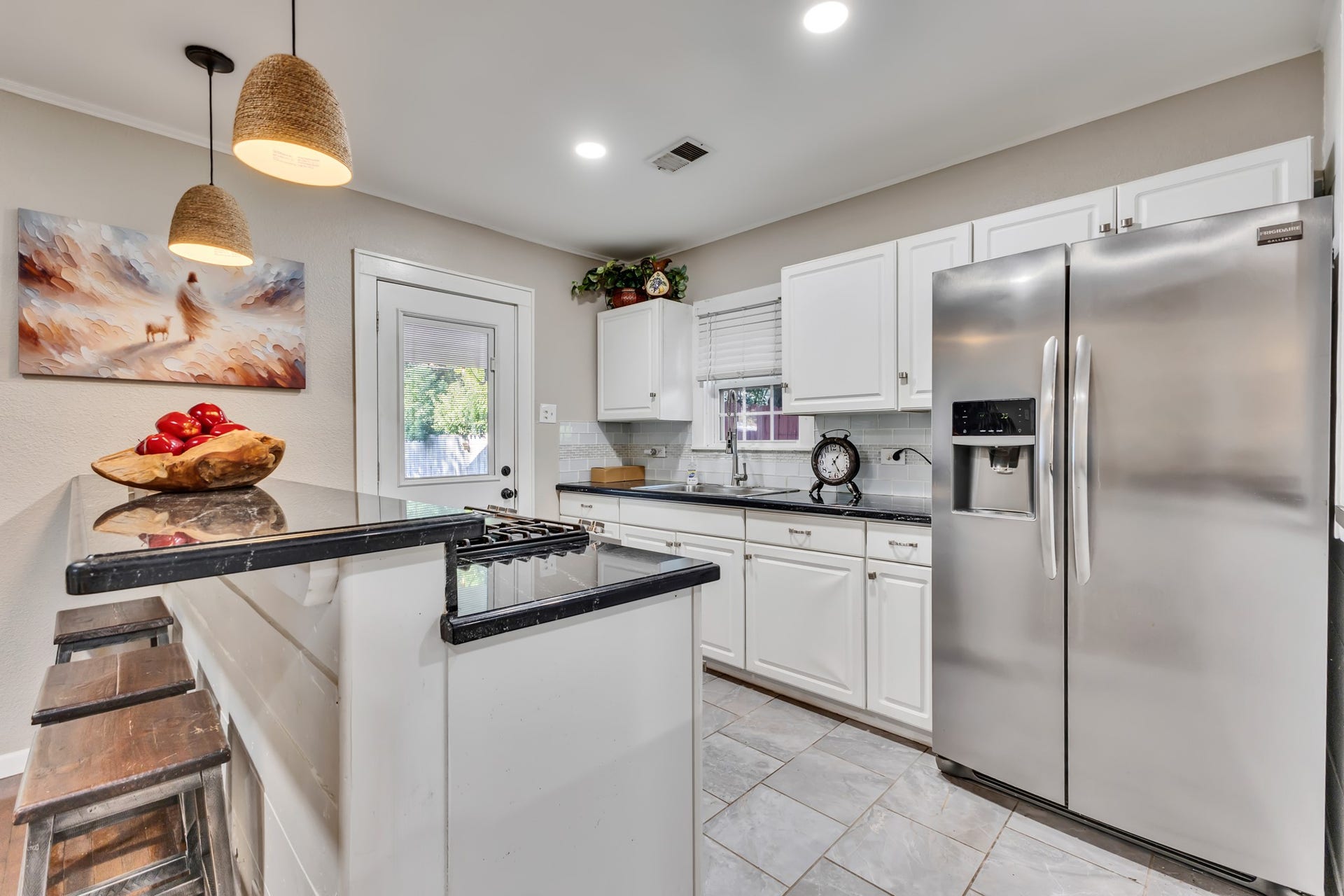 801 18th Avenue N, Texas City, TX 77590 Style and practicality come together in this inviting kitchen. White cabinetry, stainless steel appliances, and durable-looking tiled flooring create an attractive space designed for everyday use.