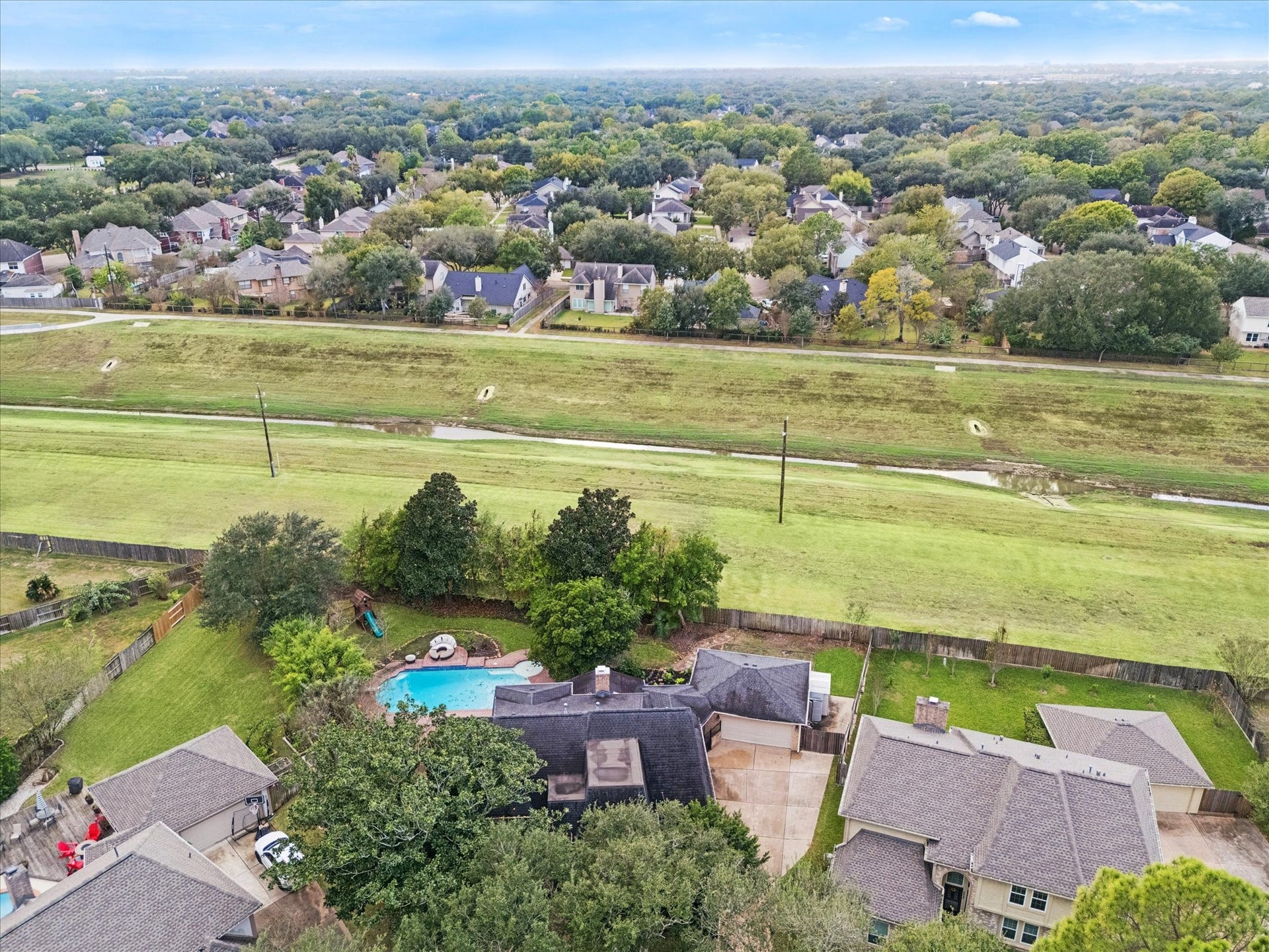 2526 STEPHENS GRANT DRIVE, Sugar Land, TX 77479 Enjoy true privacy as the property backs directly onto a wide, maintained greenway, ensuring no back neighbors and providing beautiful open views beyond the home's private backyard pool area.