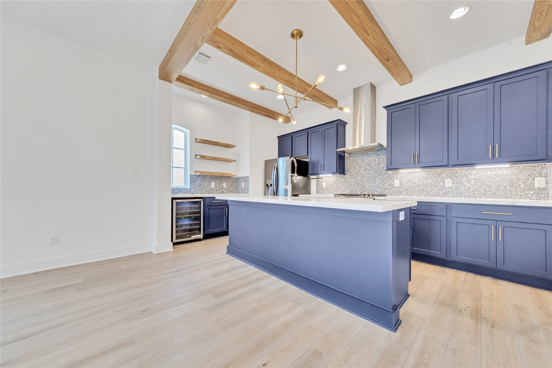 1035 W 24th Street, Houston, TX 77008 The upgraded chef's kitchen is on one end of the second floor with room for a formal dining table and large living room furniture on the other end.