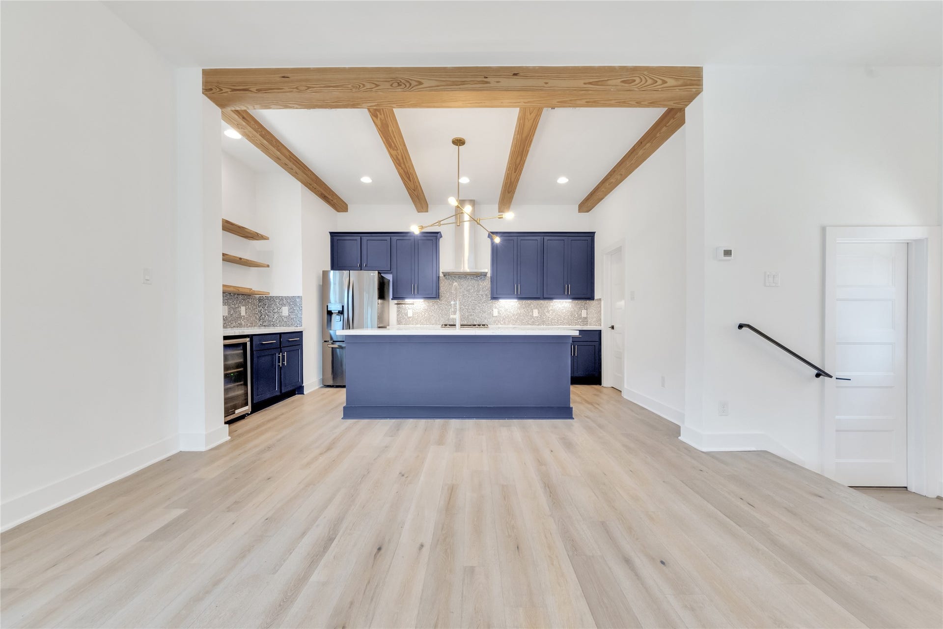 1035 W 24th Street, Houston, TX 77008 Custom beams and floating shelves warm up this modern space and are continued throughout the home.