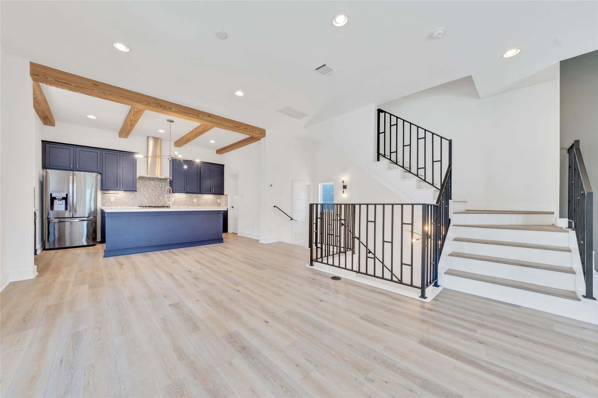 1035 W 24th Street, Houston, TX 77008 Welcome to the second floor, where you are greeted with natural light, iron stair rails, two balconies, and a fireplace.