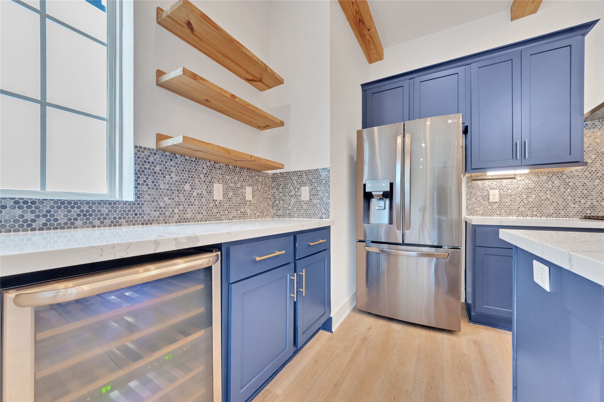 1035 W 24th Street, Houston, TX 77008 Custom floating shelves with quartz counters. Fridge and wine cooler are included!