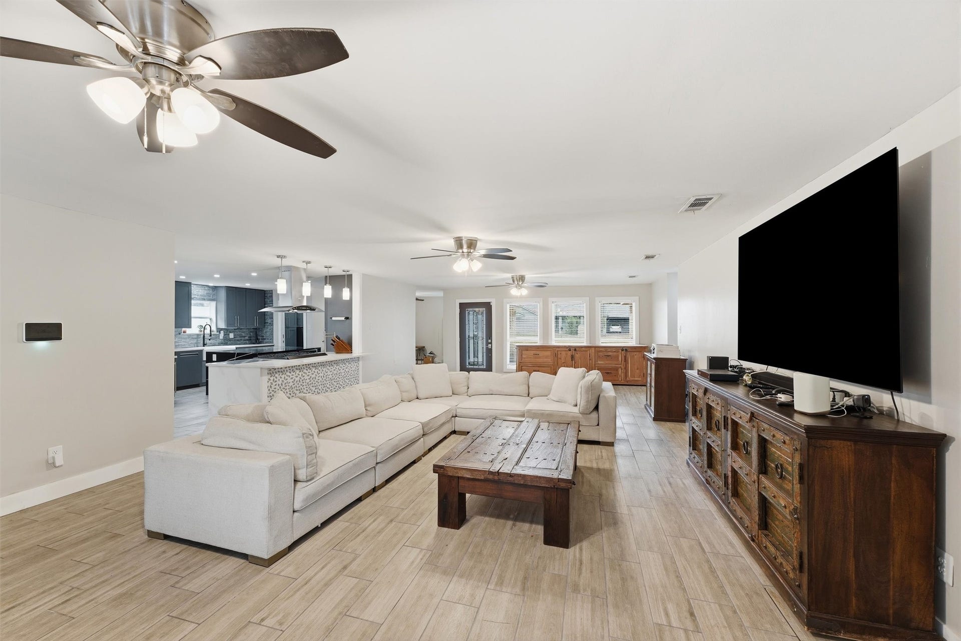 1718 Laurel Springs Lane, Kingwood, TX 77339 The living room flows seamlessly into the kitchen, creating an open and inviting space for everyday living and entertaining.