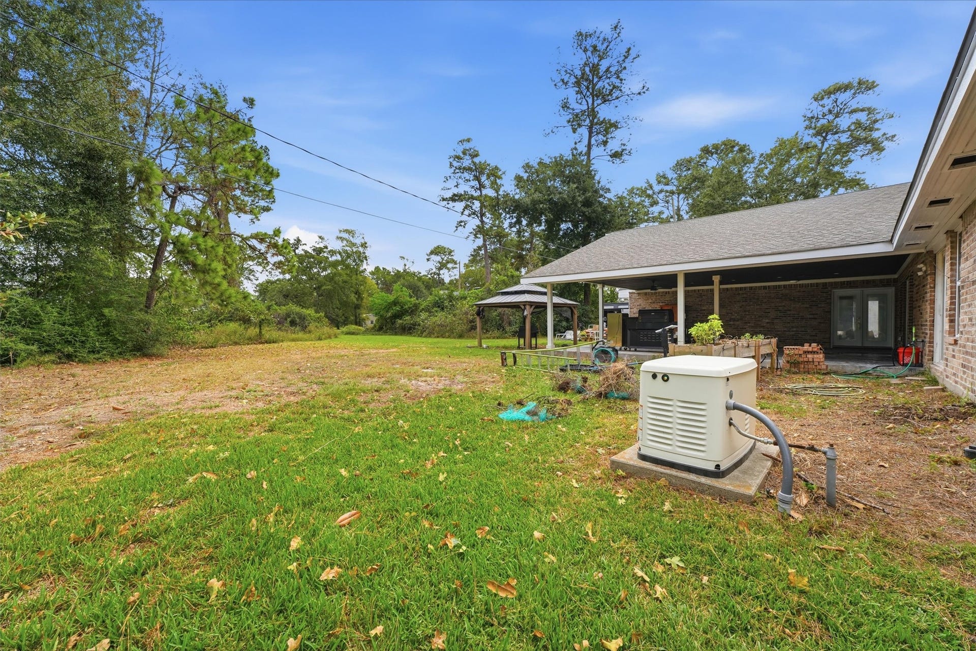 1718 Laurel Springs Lane, Kingwood, TX 77339 A view of the backyard showcases the spacious outdoor area. The open layout provides room for outdoor activities.
