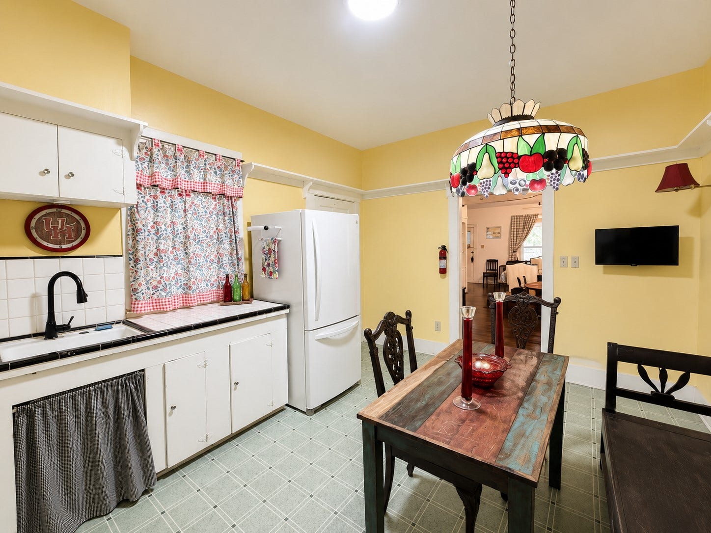 Alternate view highlights the sink area, ample cabinetry, and room for a full dining table. A wide doorway provides an easy connection to the adjoining living space.