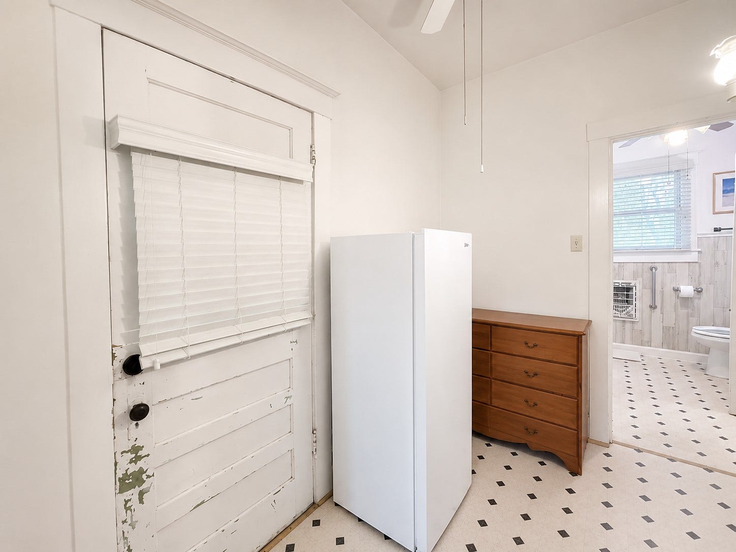 Utility/Flex Area  Bright transitional space features high ceilings, classic white trim, and access to the adjoining bathroom. The area provides additional functional space between the homes living areas.