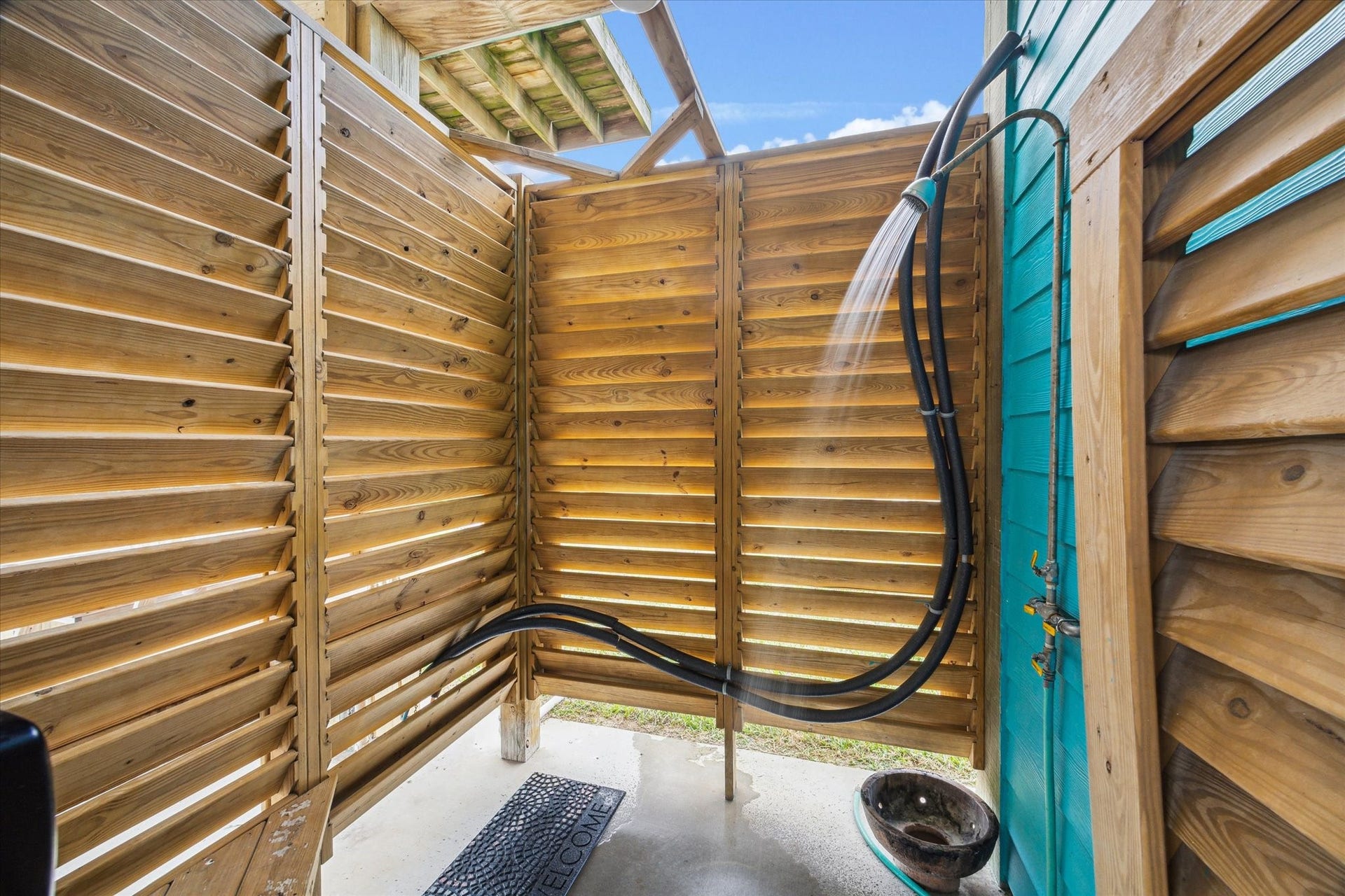 923 Tidelands Drive, Crystal Beach, TX 77650 This beach house features a convenient outdoor shower, completed with hot water, perfect for rinsing off sand and salt after a day at the beach. It offers privacy, comfort, and a refreshing way to enjoy the coastal atmosphere.
