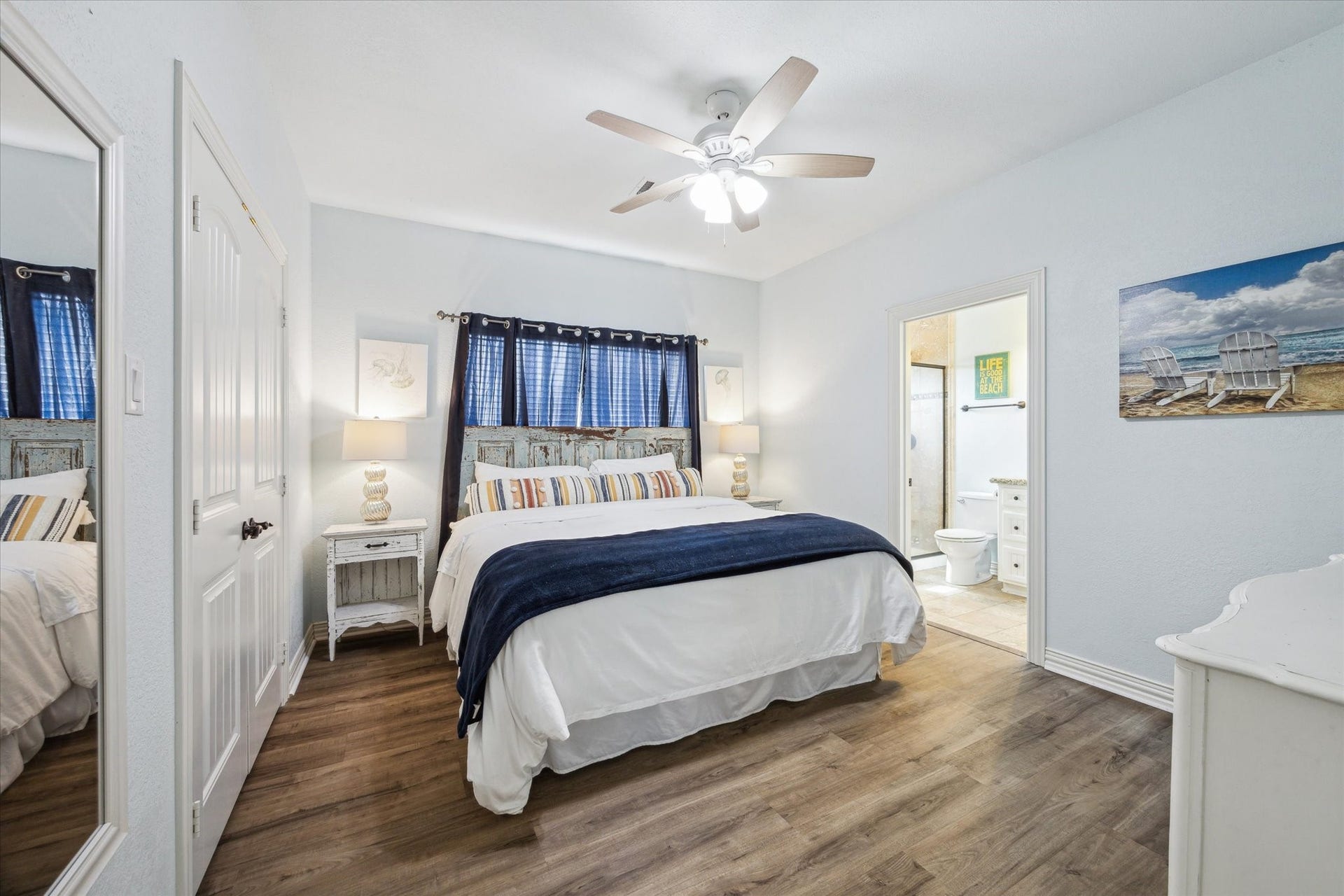 923 Tidelands Drive, Crystal Beach, TX 77650 Spacious primary bedroom filled with natural light, offering ample closet space and an ensuite bathroom featuring a walk-in shower.