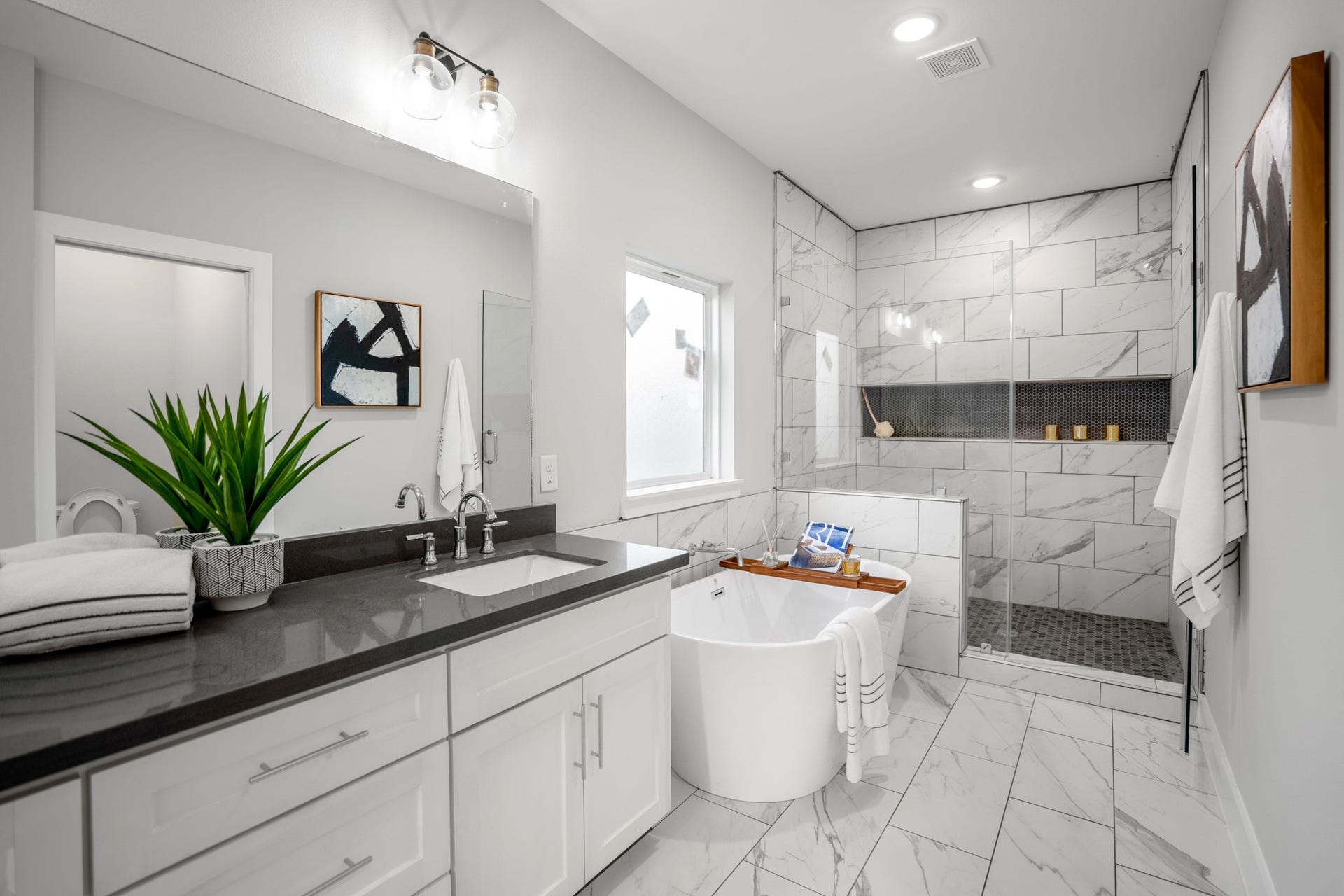 314 N Stiles Street, Houston, TX 77011 Step into the master bathroom, where dual sinks, a standalone tub, and a frameless shower offer a spa-like retreat. Photos are of previous model home.