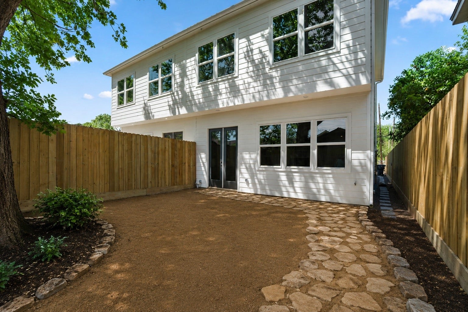 314 N Stiles Street, Houston, TX 77011 the yard unfolds as a tranquil retreat, enveloped in privacy and serenity.