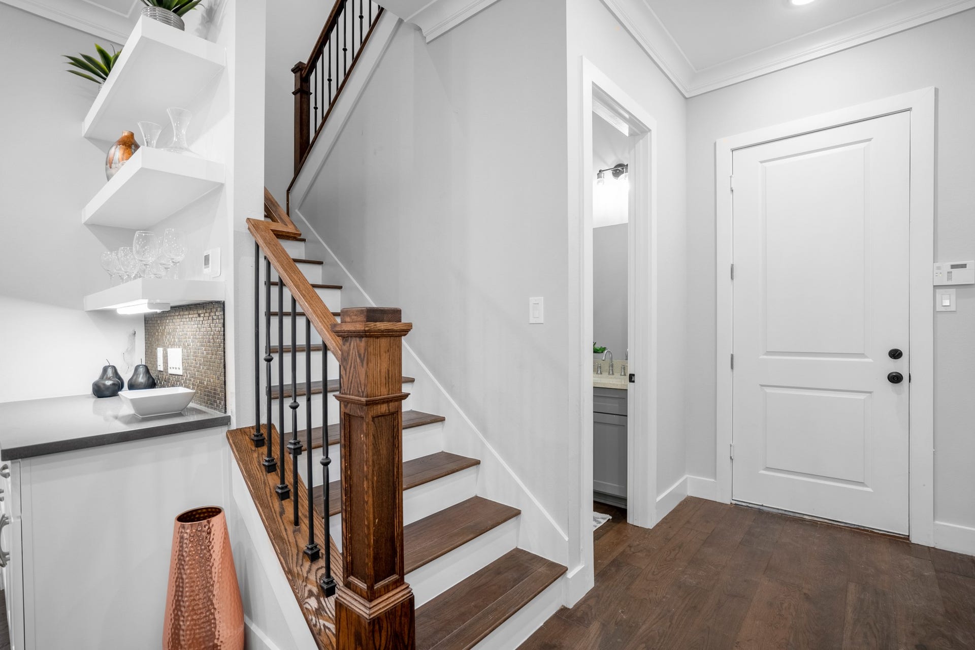 314 N Stiles Street, Houston, TX 77011 The stairwell serves as a striking architectural accent, with its graceful and sleek railing design adding visual interest and sophistication to the home's interior. Photos are of previous model home.