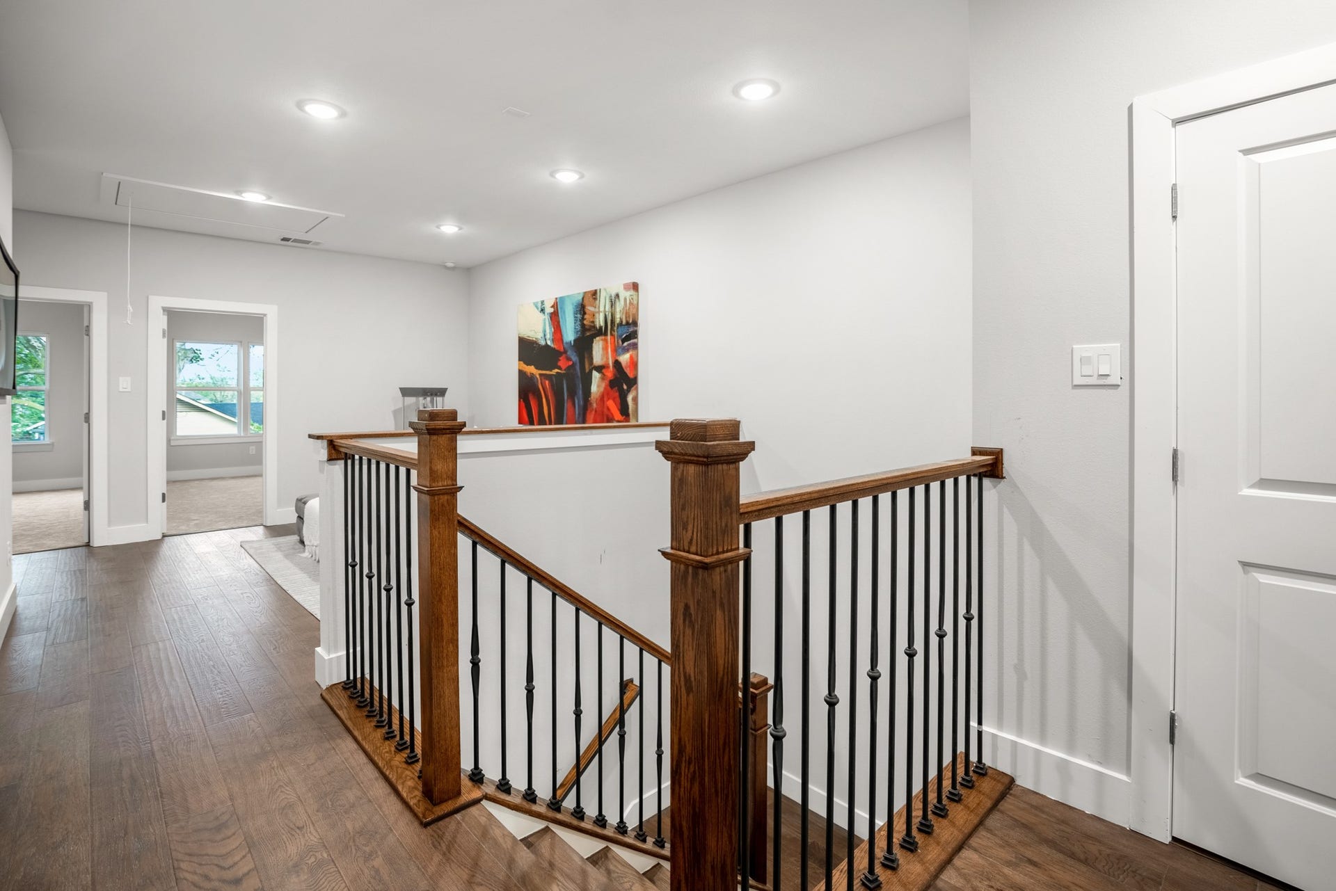 314 N Stiles Street, Houston, TX 77011 the stairwell invites you to ascend to the upper levels with a sense of elegance and grace. Photos are of previous model home.