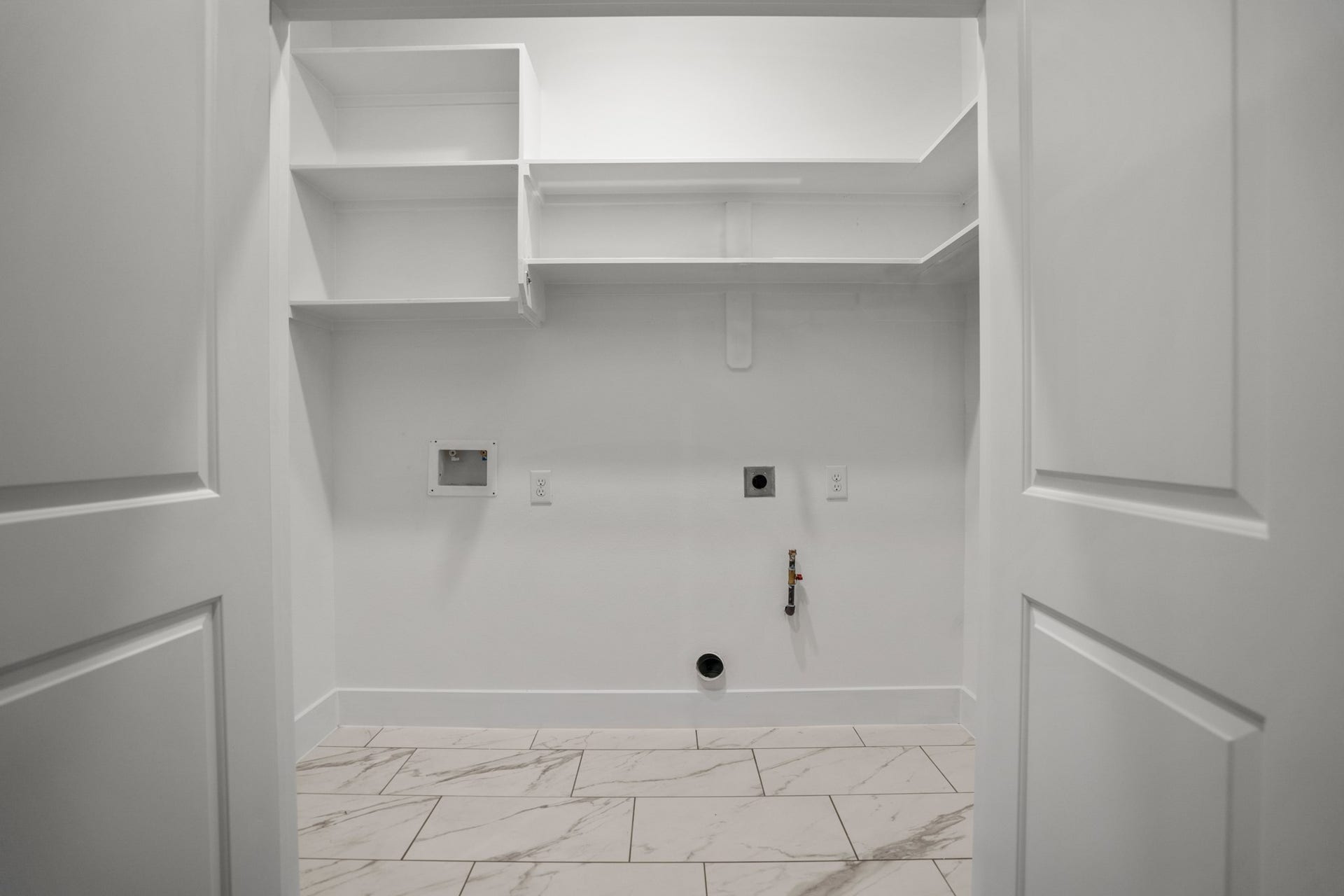 314 N Stiles Street, Houston, TX 77011 The laundry room serves as a functional hub for household chores, offering a well-organized space equipped with modern appliances and ample storage solutions. Photos are of previous model home.