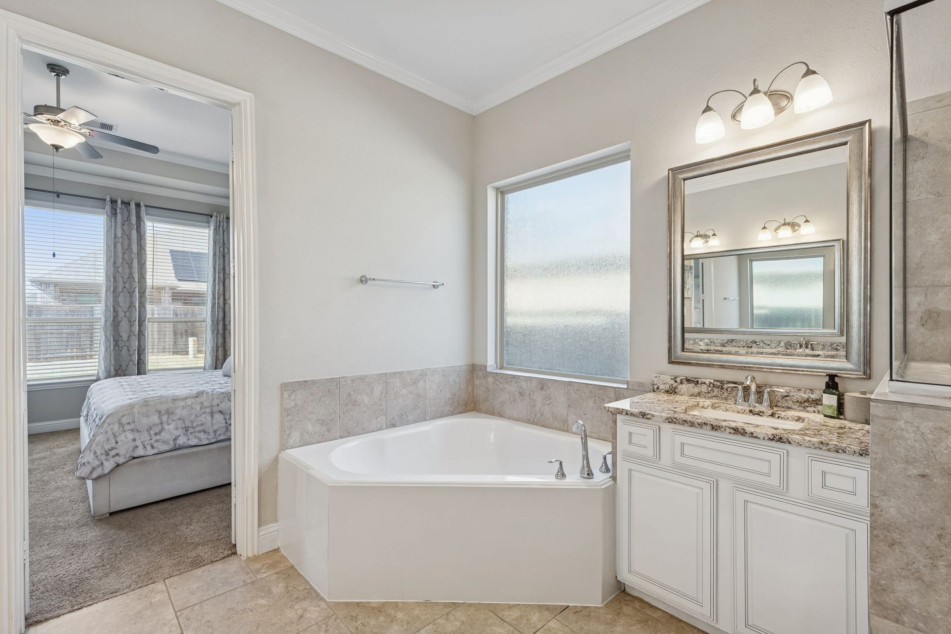 1619 Dove Ridge Drive, Katy, TX 77493 The Primary Bath is a true sanctuary, featuring a deep corner soaking tub and elegant granite-topped dual vanities.