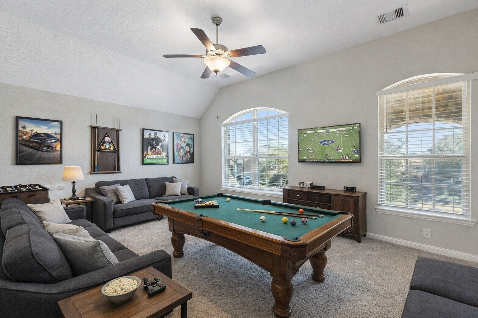 1619 Dove Ridge Drive, Katy, TX 77493 The expansive upstairs gameroom features high ceilings and large windows, providing a versatile space for play or relaxation. Virtually staged so you can imagine possibilities.