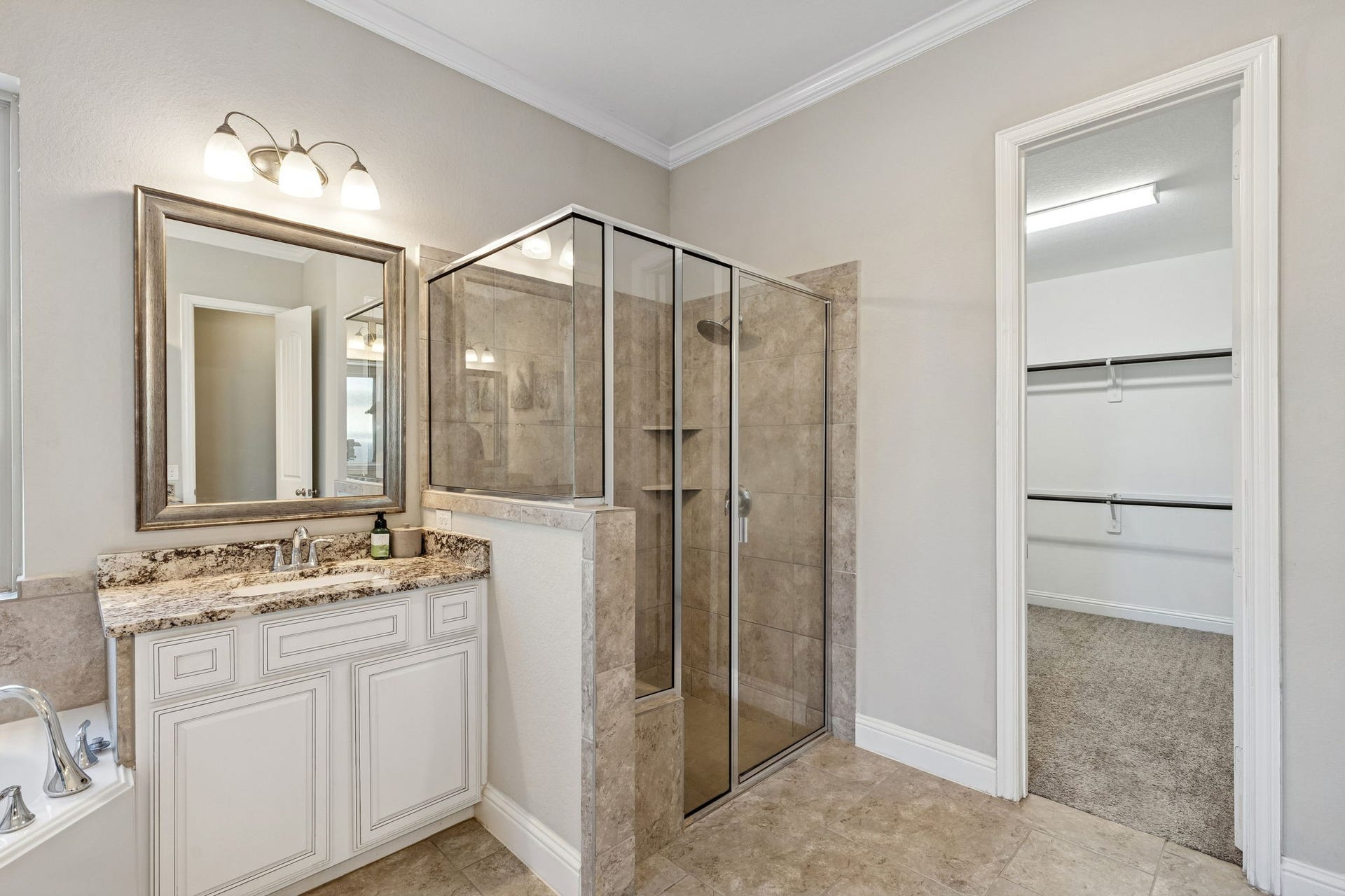 1619 Dove Ridge Drive, Katy, TX 77493 Experience modern luxury in the primary bathroom, which offers a spacious walk-in shower with designer tile and a frameless glass enclosure. The layout provides a seamless transition to the primary closet.