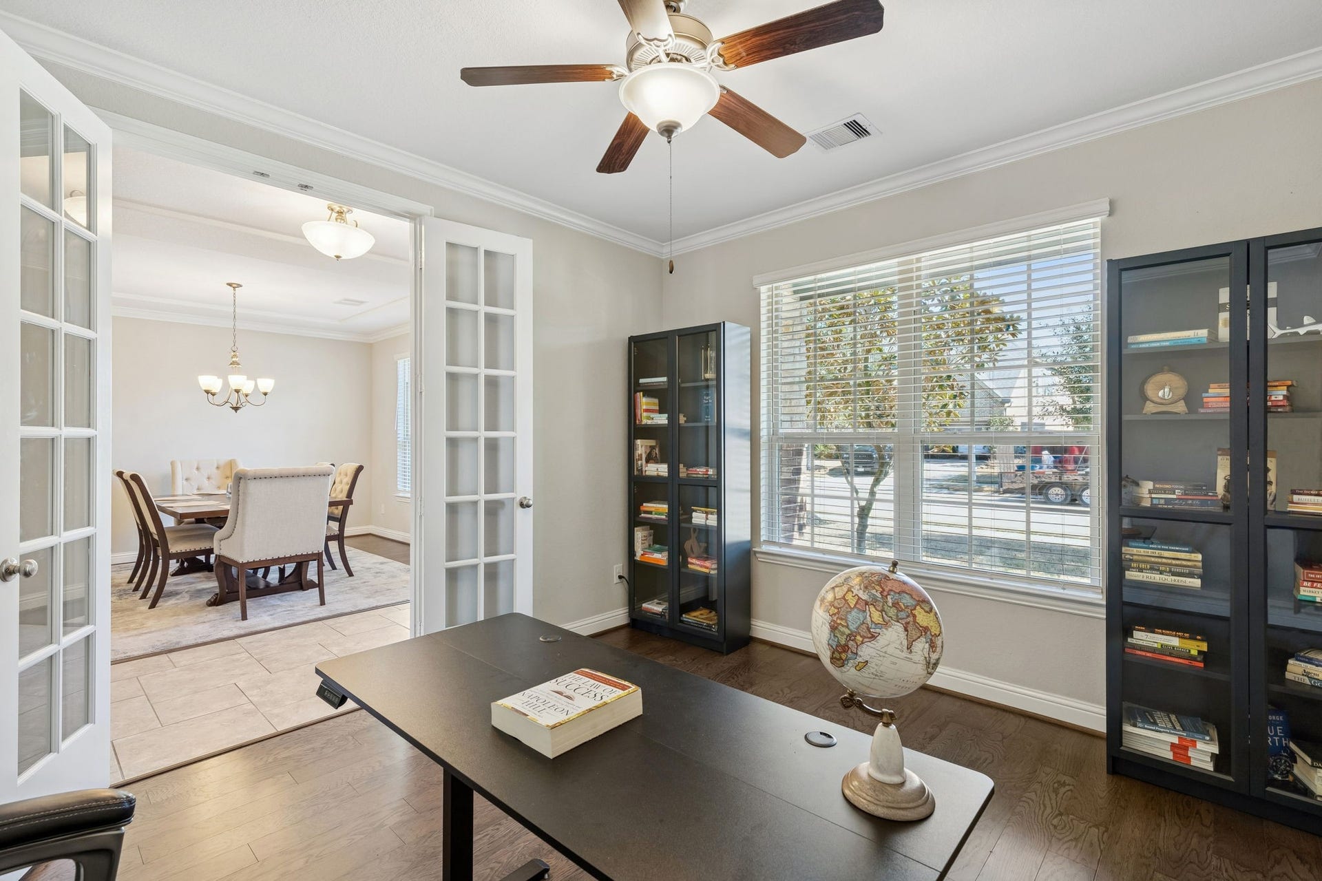 1619 Dove Ridge Drive, Katy, TX 77493 Work from home in style within this private study secured by elegant double French doors. The room features warm engineered wood floors and a wall of windows.