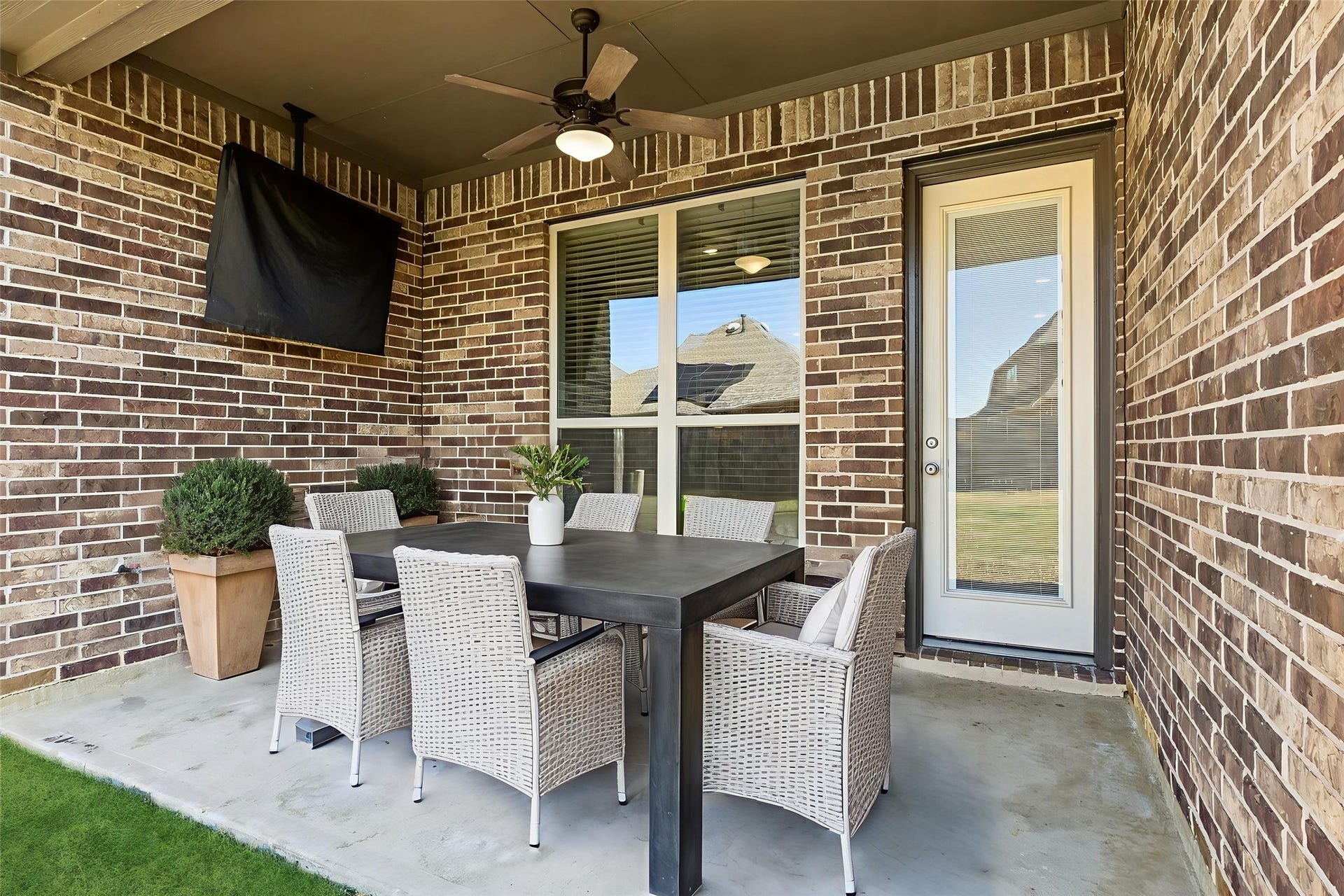 1619 Dove Ridge Drive, Katy, TX 77493 The covered patio offers plenty of space for a lounge setup or outdoor dining, creating a versatile area to enjoy the backyard. Virtually staged.