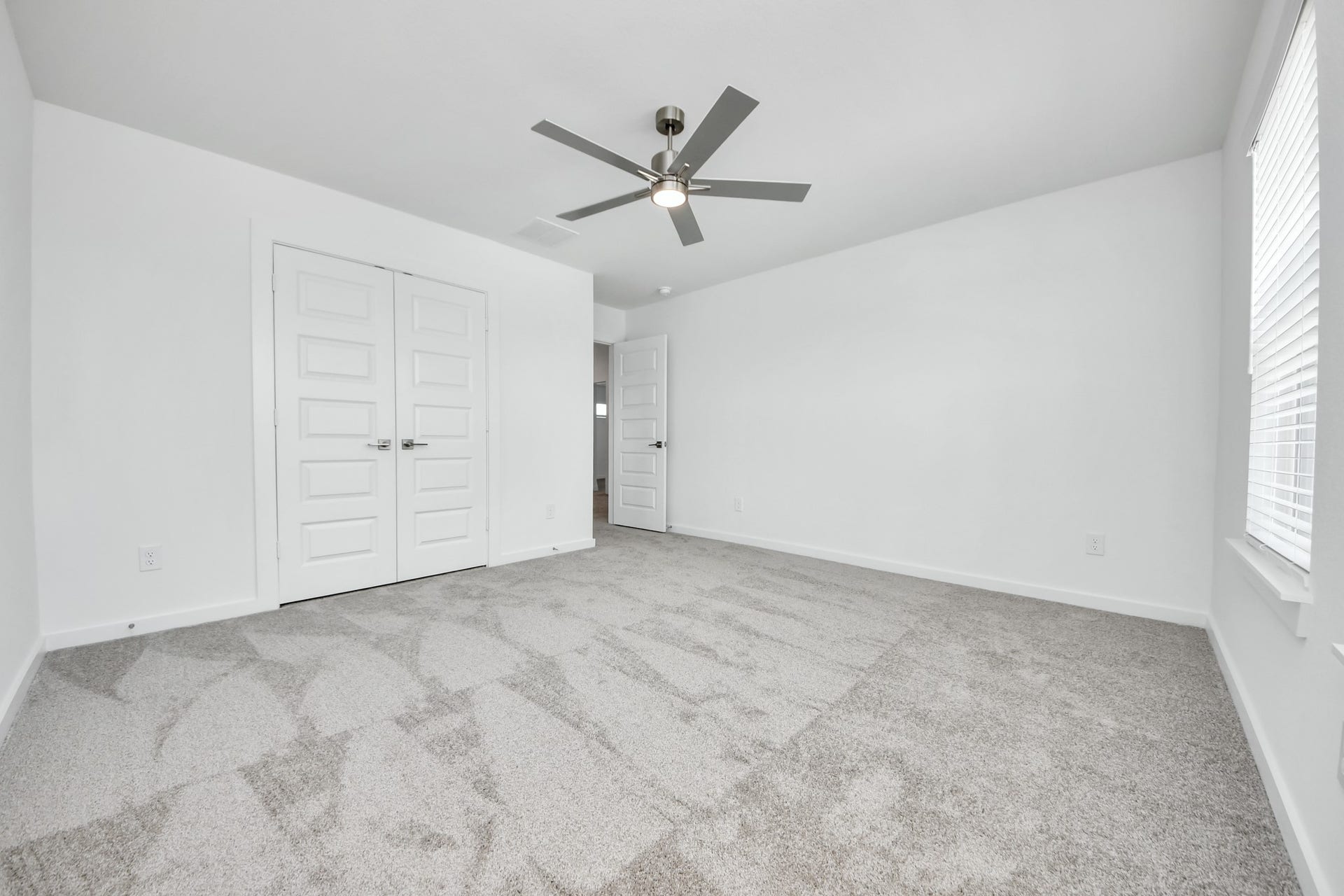 5906 Fox Peak Lane, Richmond, TX 77469 Generously sized secondary bedrooms featuring spacious closets, soft and inviting carpeting underfoot, large windows allowing plenty of natural light, and the added touch of privacy blinds for your personal retreat. Sample photo of completed home with similar floor plan. Actual colors and selections may vary.