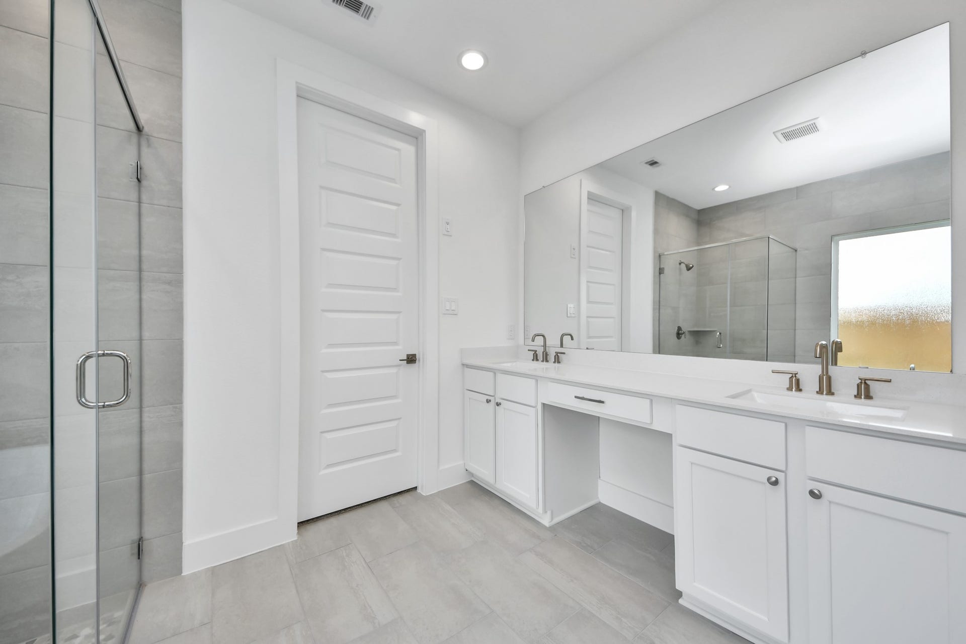 5906 Fox Peak Lane, Richmond, TX 77469 Elevate your daily routine at the elegant vanity, now equipped with double sinks, light countertops, modern hardware, and beautiful recessed lights. Sample photo of completed home with similar floor plan. Actual colors and selections may vary.