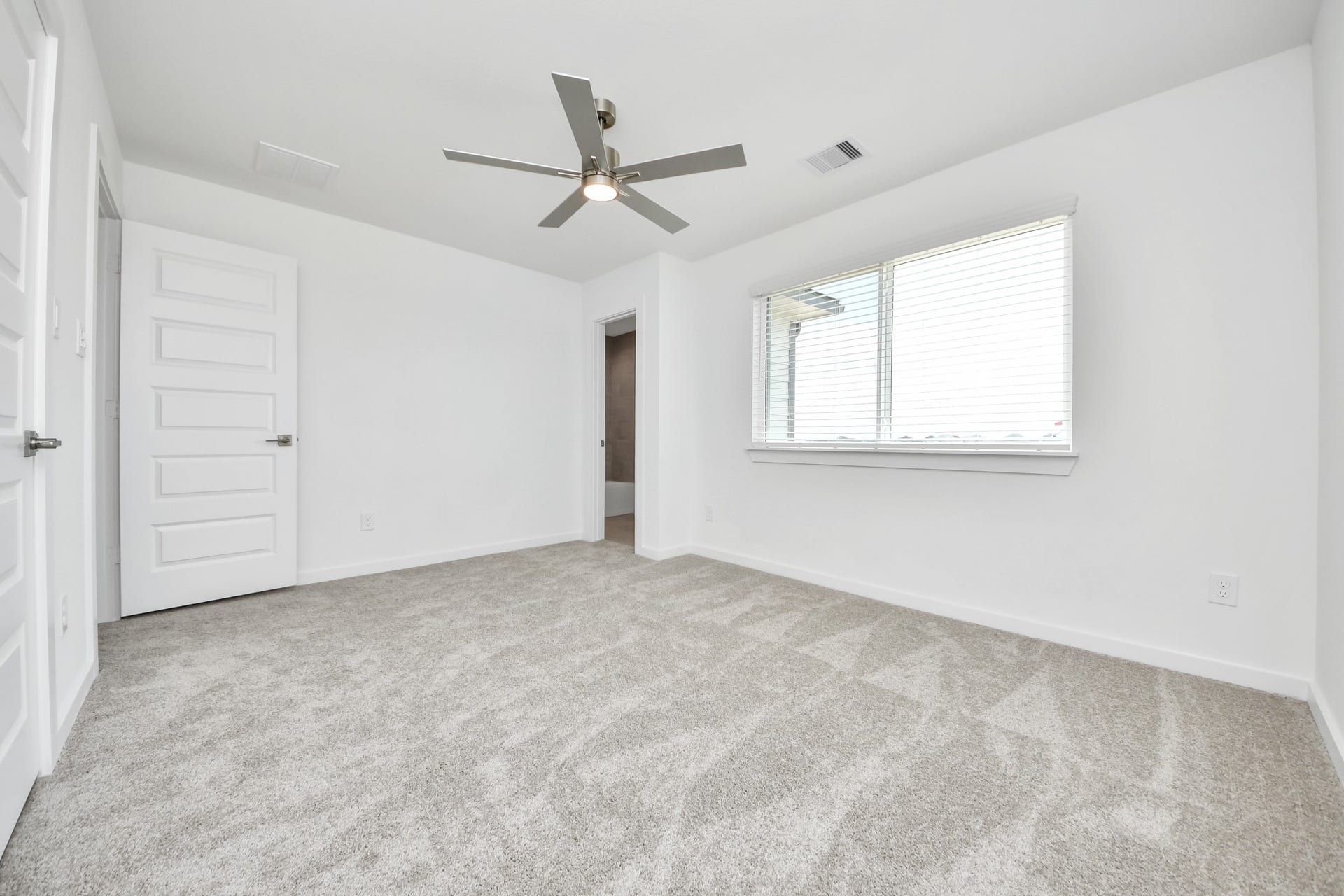 5906 Fox Peak Lane, Richmond, TX 77469 Generously sized secondary bedrooms featuring spacious closets, soft and inviting carpeting underfoot, large windows allowing plenty of natural light, and the added touch of privacy blinds for your personal retreat. Sample photo of completed home with similar floor plan. Actual colors and selections may vary.