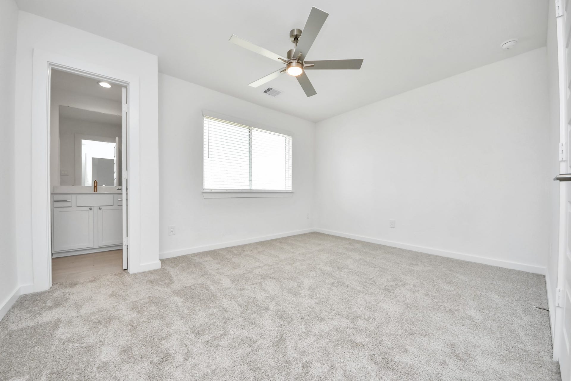 5906 Fox Peak Lane, Richmond, TX 77469 Secondary bedroom features plush carpeting, large windows that let in plenty of natural light, bright paint, and spacious closets. Sample photo of completed home with similar floor plan. Actual colors and selections may vary.