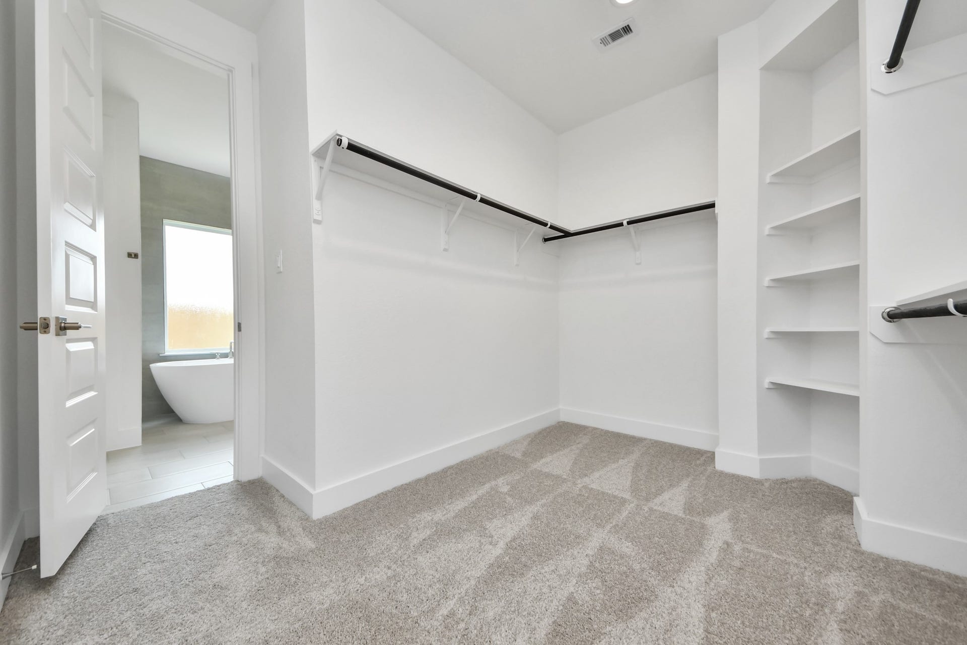 5906 Fox Peak Lane, Richmond, TX 77469 Walk-in closet that epitomizes luxury and practicality. This generously sized space features built-in shelving, offering abundant room for impeccable organization. High ceilings and recessed lighting create a bright and welcoming ambiance. Sample photo of completed home with similar floor plan. Actual colors and selections may vary.