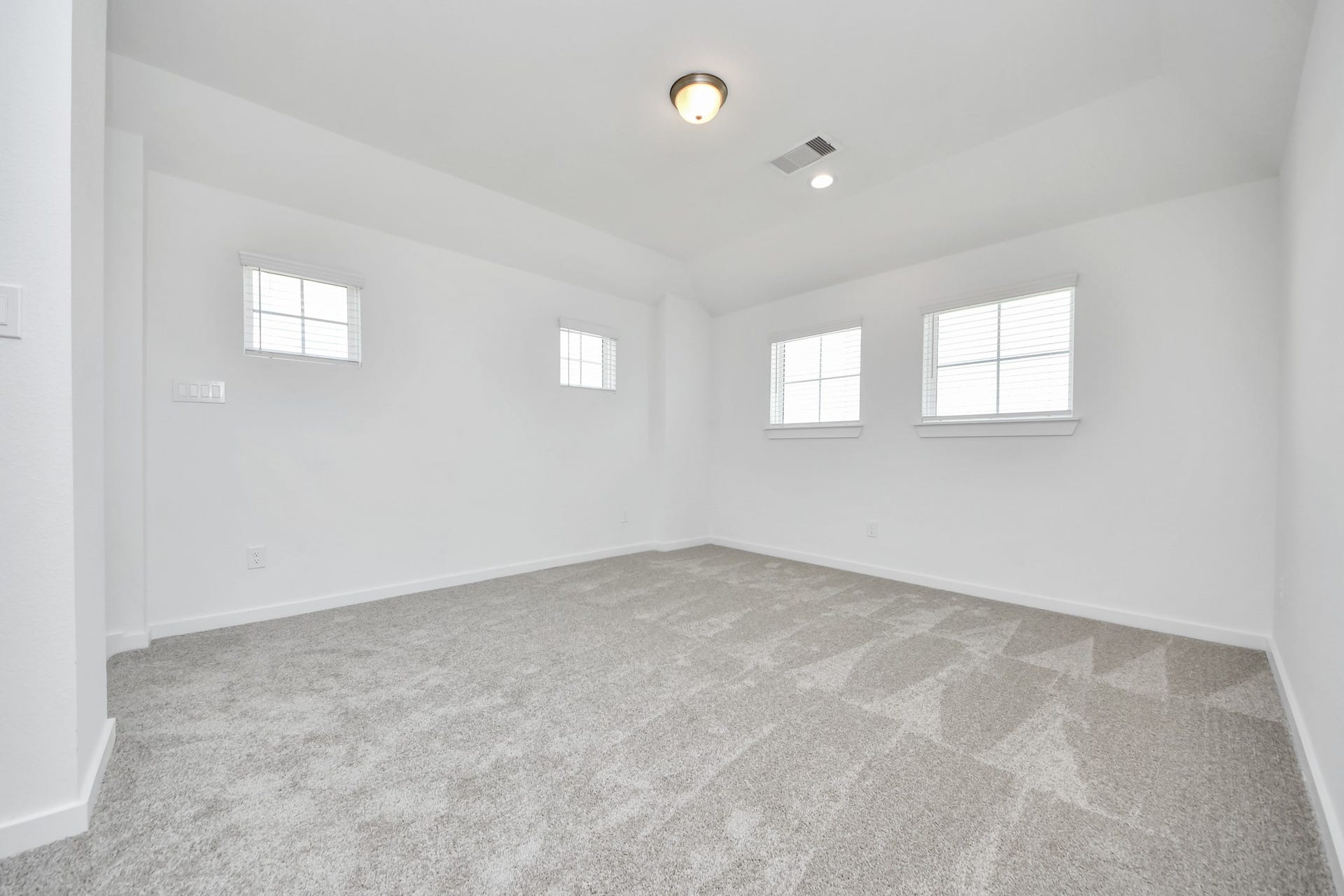 5906 Fox Peak Lane, Richmond, TX 77469 Come upstairs and enjoy a day of leisure in this fabulous game room! This is the perfect hangout spot or adult game room! Features plush carpet, high ceilings, custom paint and windows for plenty of natural light. Sample photo of completed home with similar floor plan. Actual colors and selections may vary.