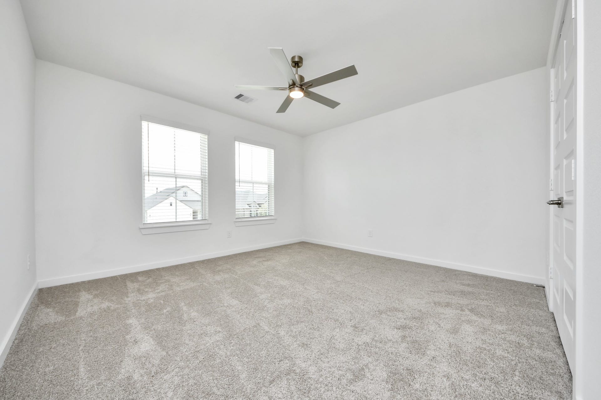 5906 Fox Peak Lane, Richmond, TX 77469 Secondary bedroom features plush carpeting, large windows that let in plenty of natural light, bright paint, and spacious closets. Sample photo of completed home with similar floor plan. Actual colors and selections may vary.