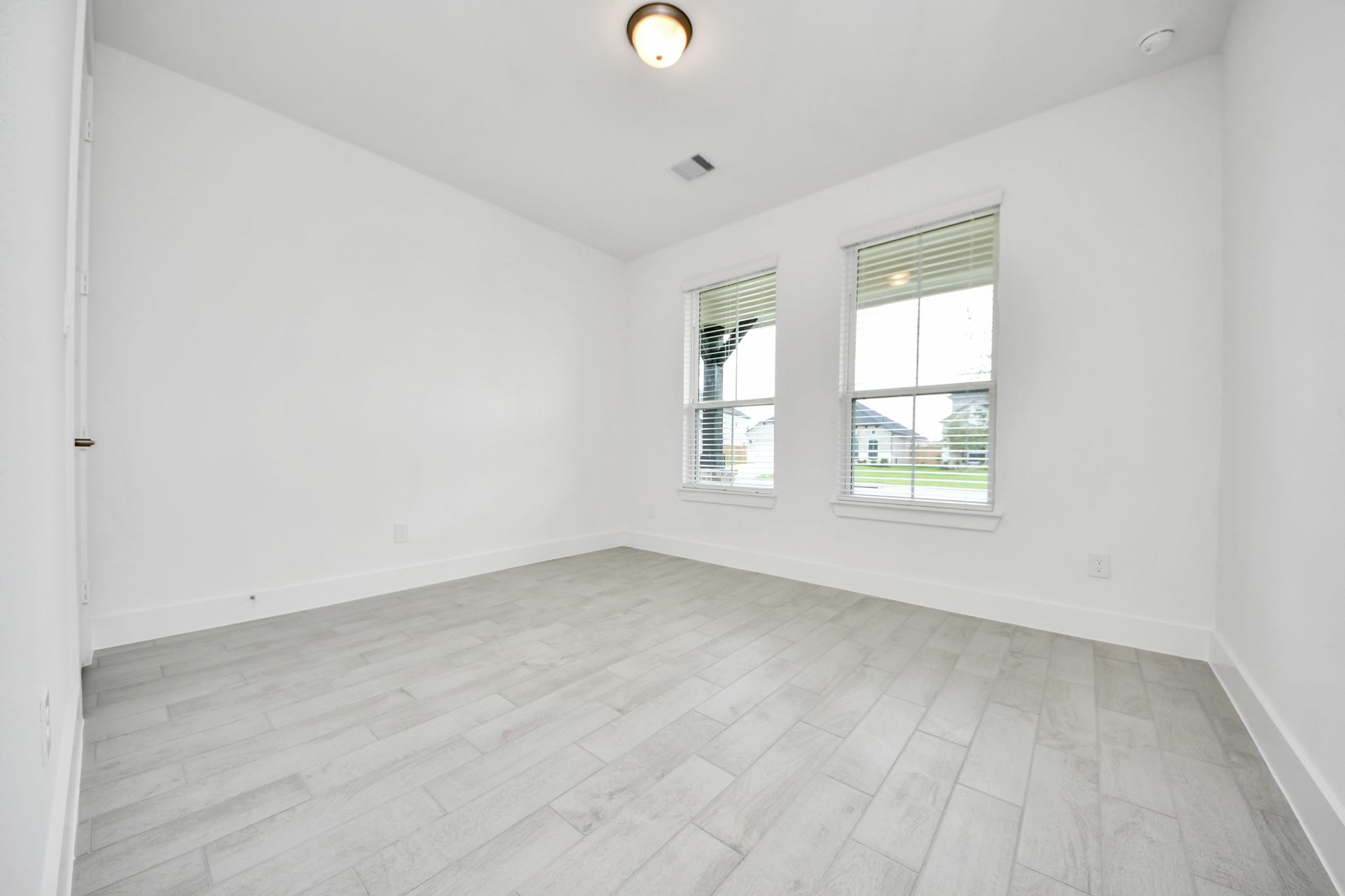 5906 Fox Peak Lane, Richmond, TX 77469 Secondary bedroom features plush carpeting, large windows that let in plenty of natural light, bright paint, and spacious closets. Sample photo of completed home with similar floor plan. Actual colors and selections may vary.