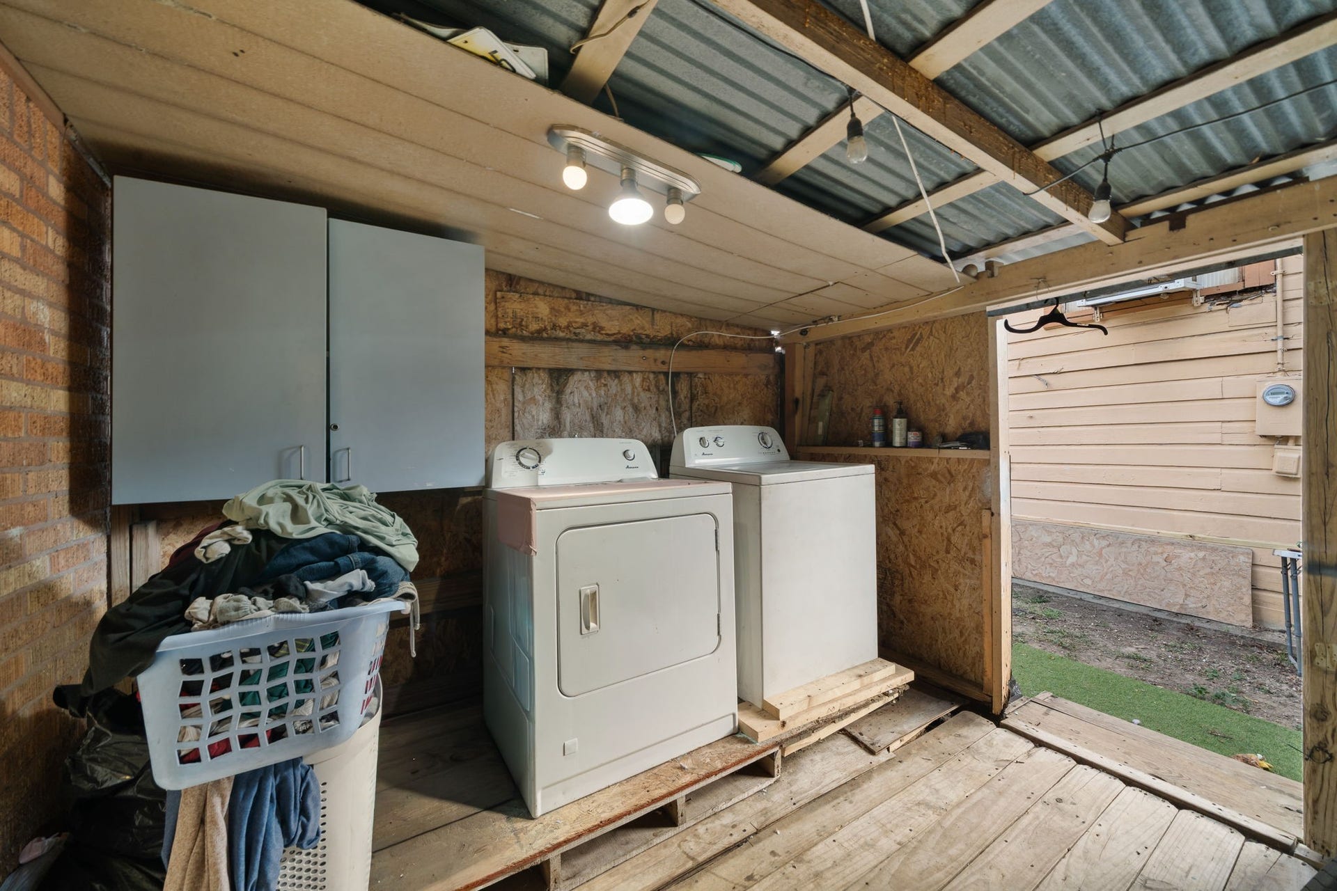 1821 Hatwell Street, Houston, TX 77023 Covered washer and dryer area with lots of storage.