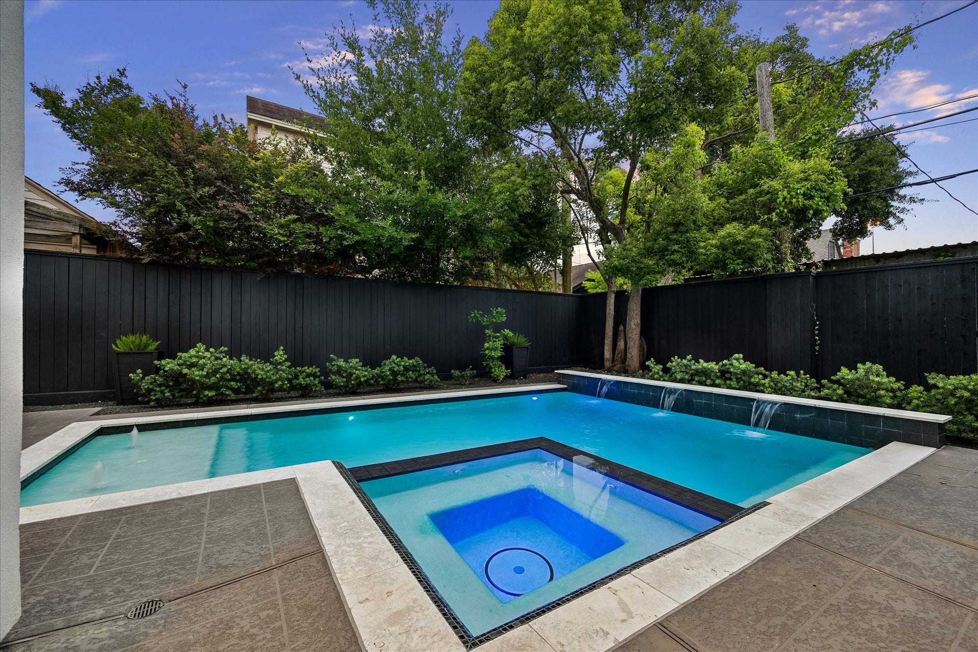 1959 Portsmouth Street, Houston, TX 77098 Surrounding the pool and spa is beautiful green landscaping.