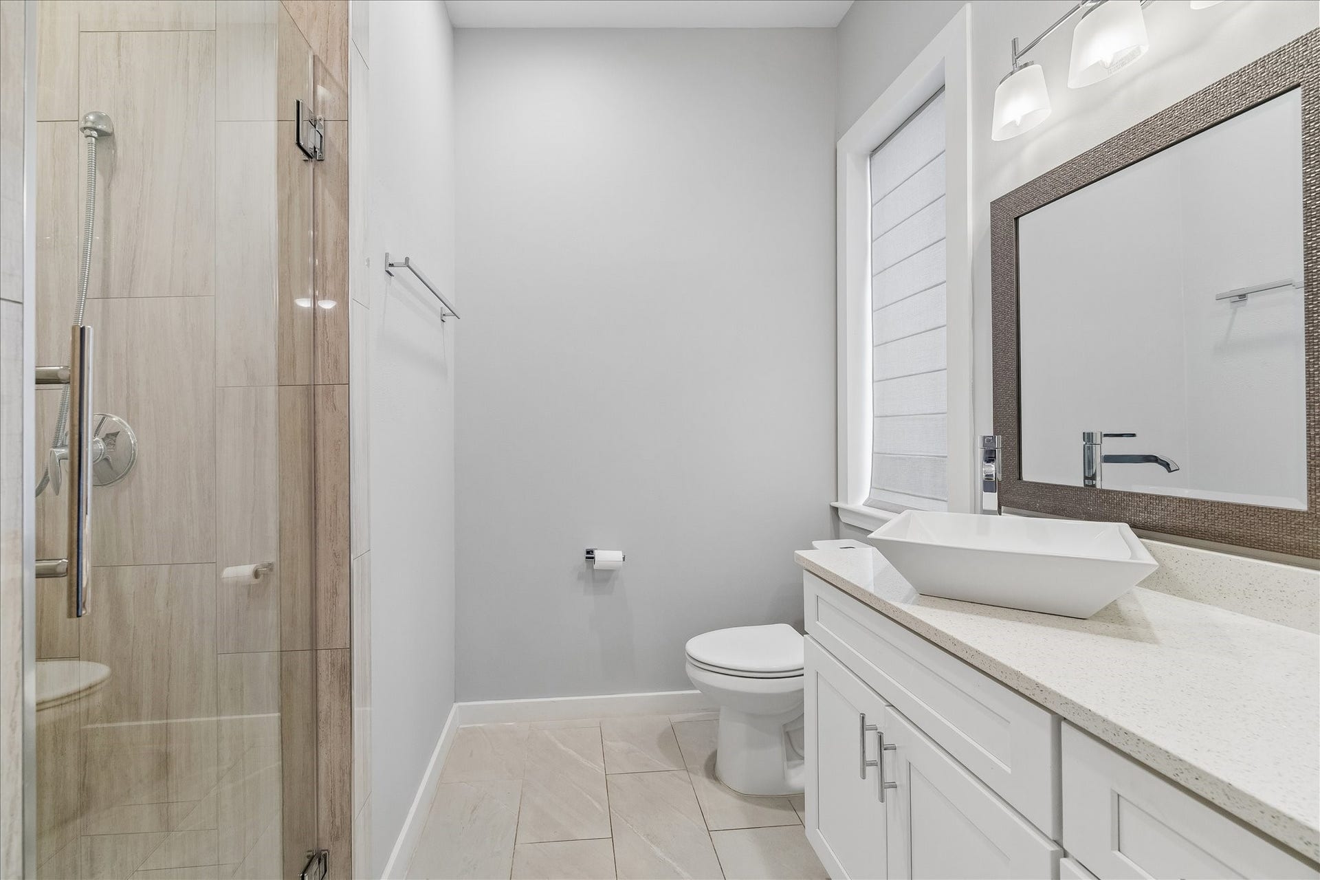 1959 Portsmouth Street, Houston, TX 77098 This bathroom has a large window
that gives plenty of natural light and
a custom shower with glass door that
was re-tiled when the owners
purchased it.