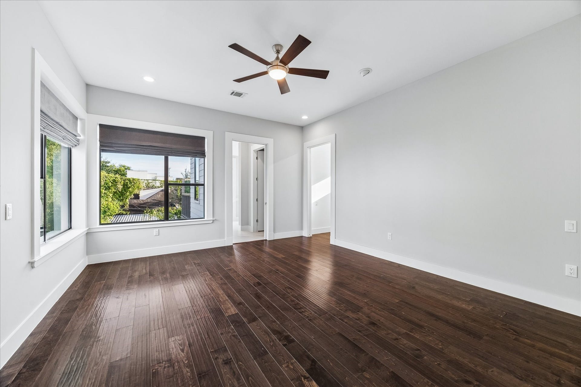 1959 Portsmouth Street, Houston, TX 77098 At the end of the hallway, step into
the luxurious primary suite with tons
of windows and back accent wall.